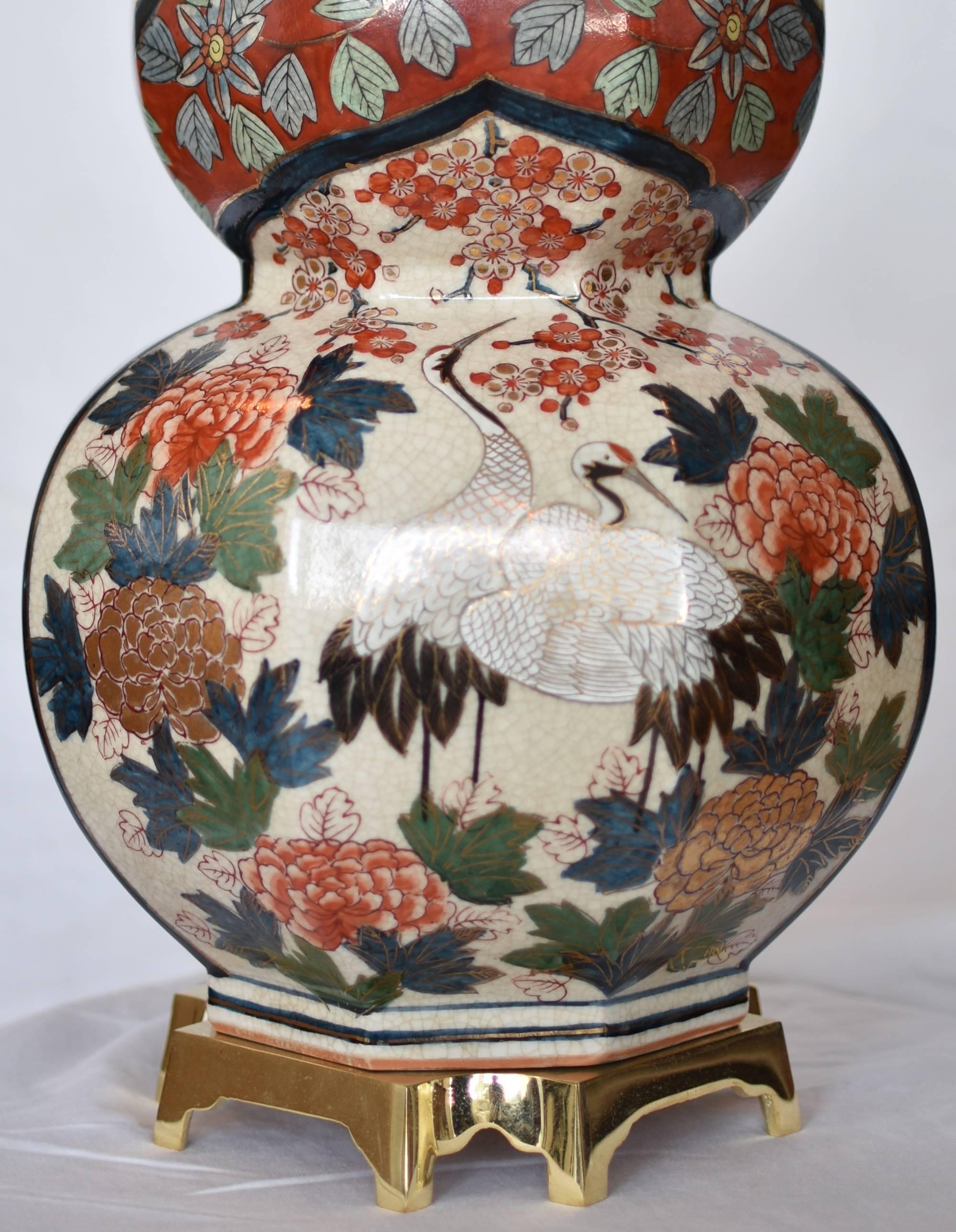 Exquisite large Japanese contemporary gilded and intricately hand painted porcelain table lamp in an auspicious double gourd crackled fine porcelain body in red and green, showcasing two panels with creamy white background, one depicting two