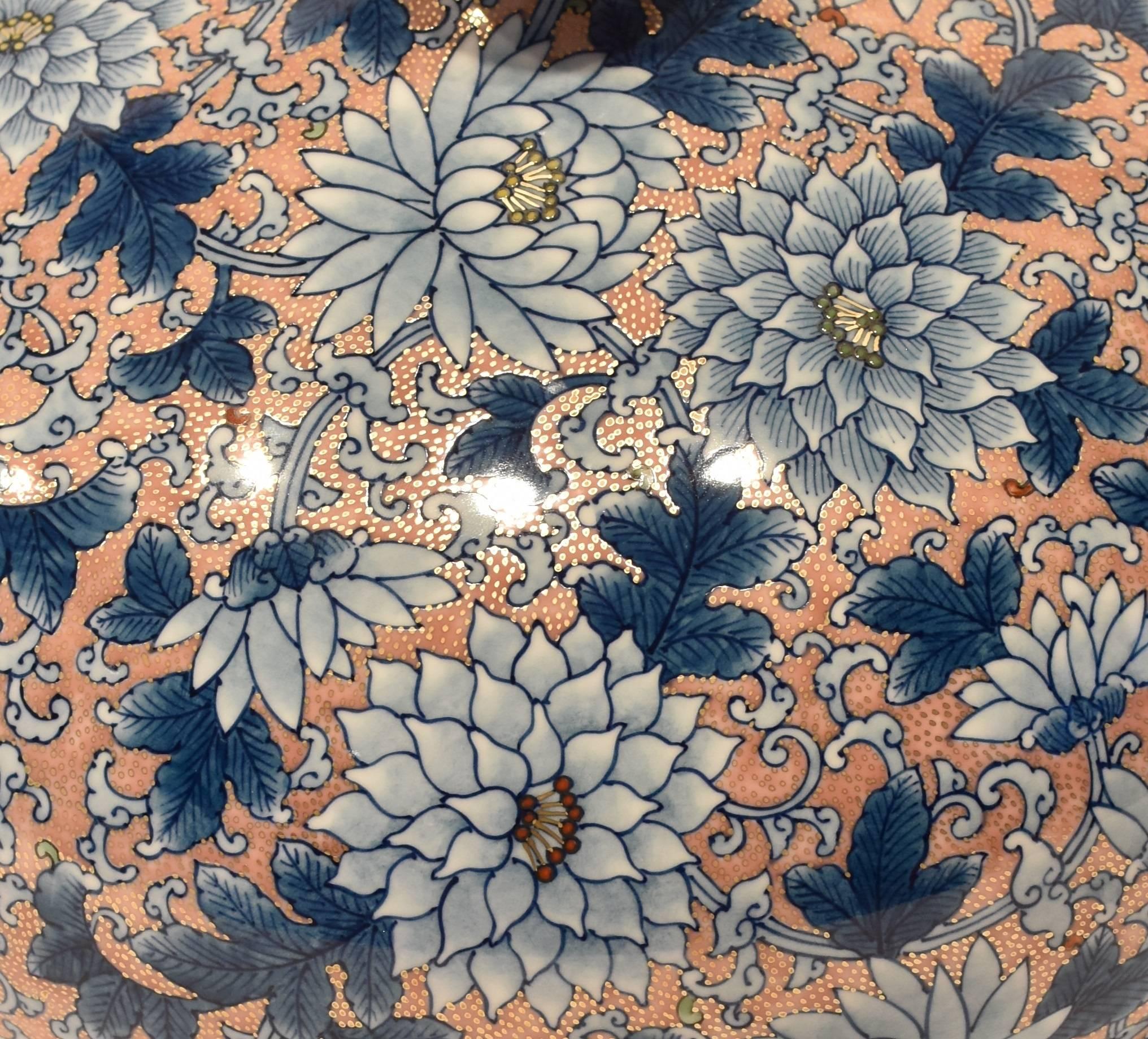 This unique one-of-a-kind contemporary hand-painted decorative piece on the finest Arita porcelain boasts an exaggerated ovoid shape that provides the perfect canvas for a field of chrysanthemums in full bloom. Flowers done in shades of blue are set