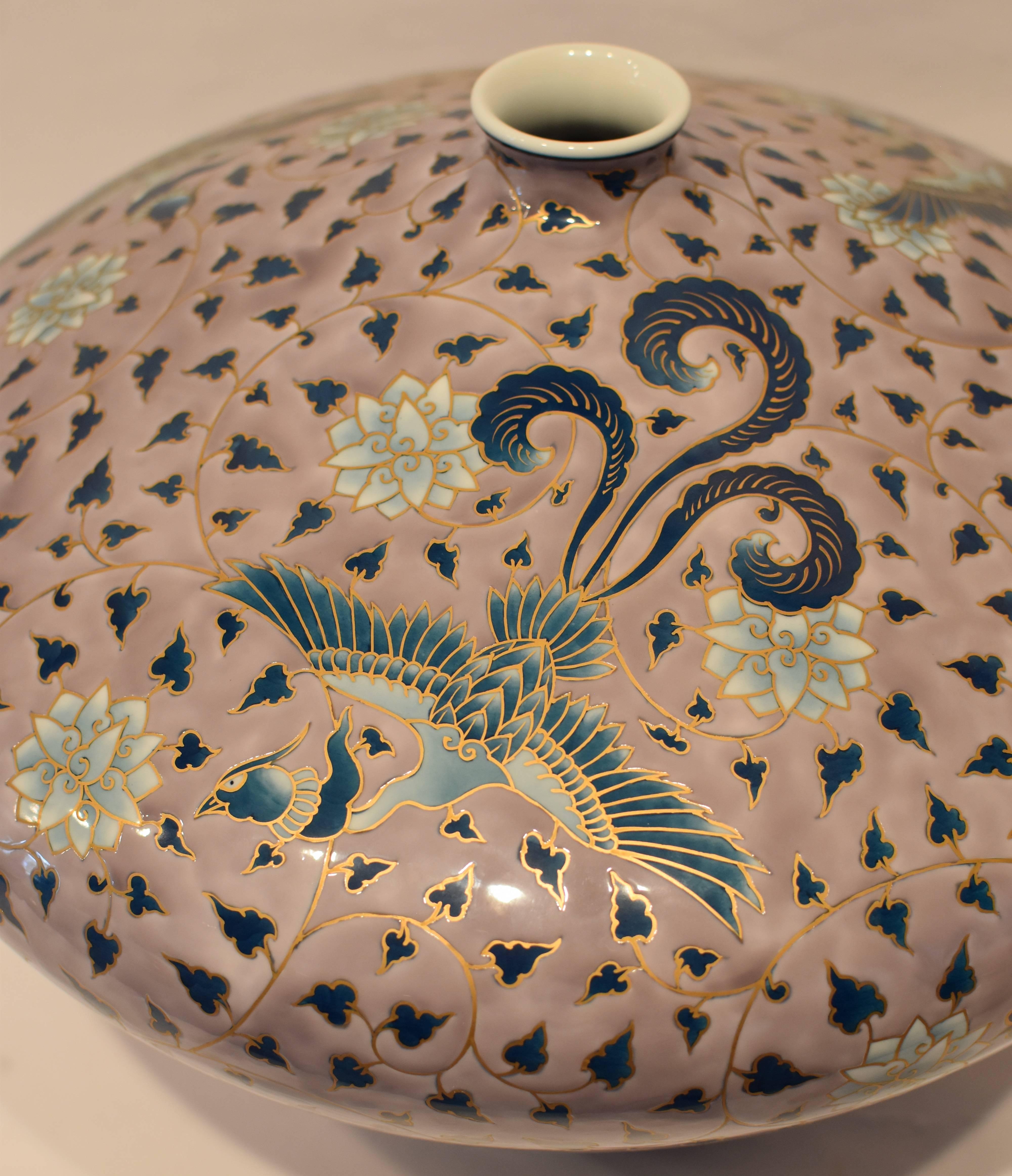 This exquisite one-of-a-kind contemporary Japanese vase, hand-painted on fine Arita porcelain is a stunning soft purple color, comes in an unusual “diamond” shape. The entire body is covered with an arabesque motif interspersed with phoenixes and