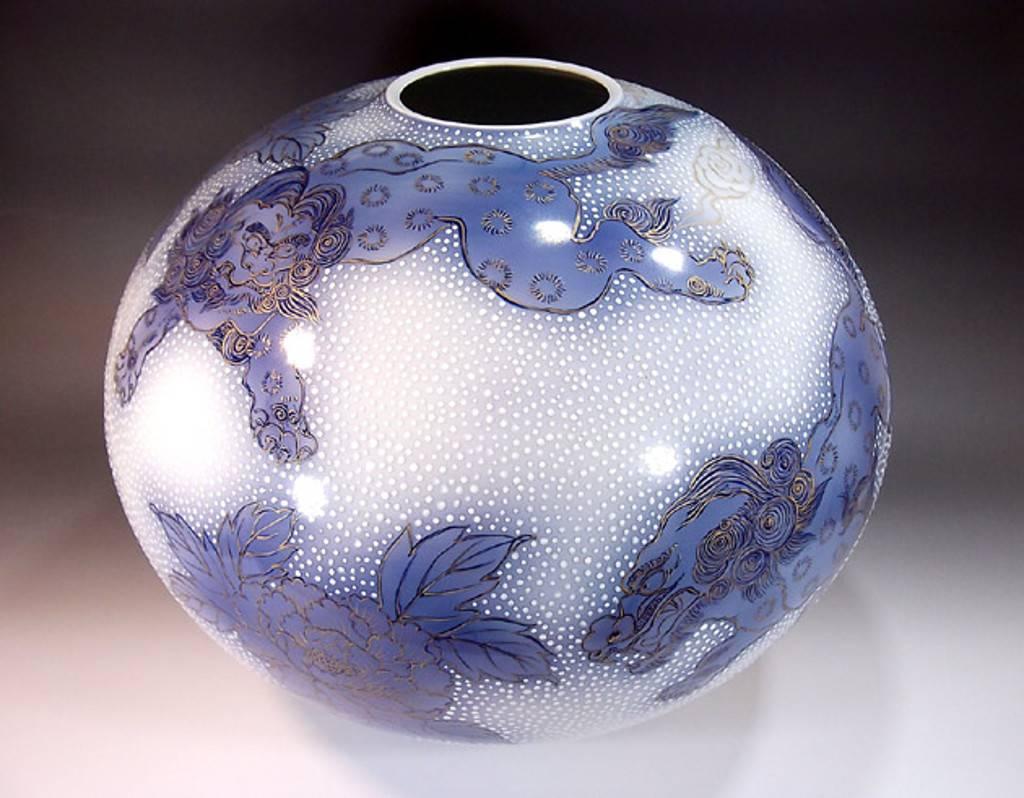 This superb Japanese contemporary ovoid porcelain vase, hand-painted in beautiful shades of blue on an elegantly shaped ovoid porcelain body with generous gold details, is by Fujii Tadashi, a master porcelain artist in the Imari-Arita tradition.
In