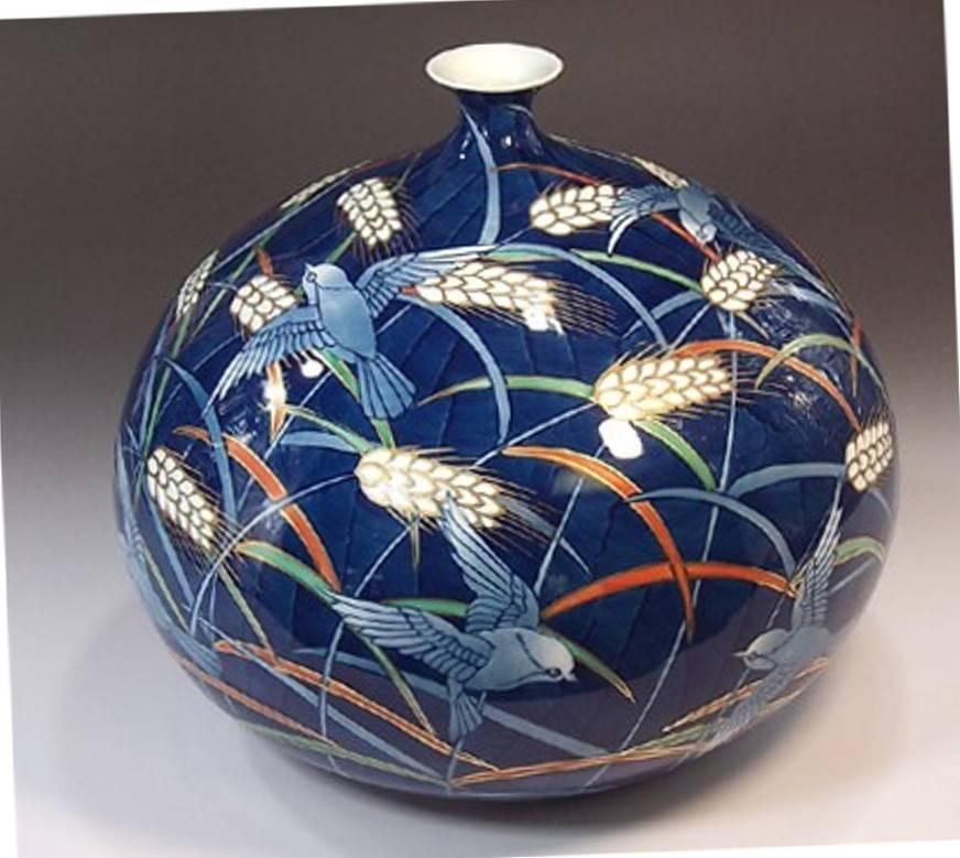 Exquisite Japanese Contemporary porcelain decorative vase, extremely intricately hand painted in blue, white and orange on an elegantly shaped porcelain body, a signed piece by highly acclaimed Japanese master porcelain artist in the Imari-Arita