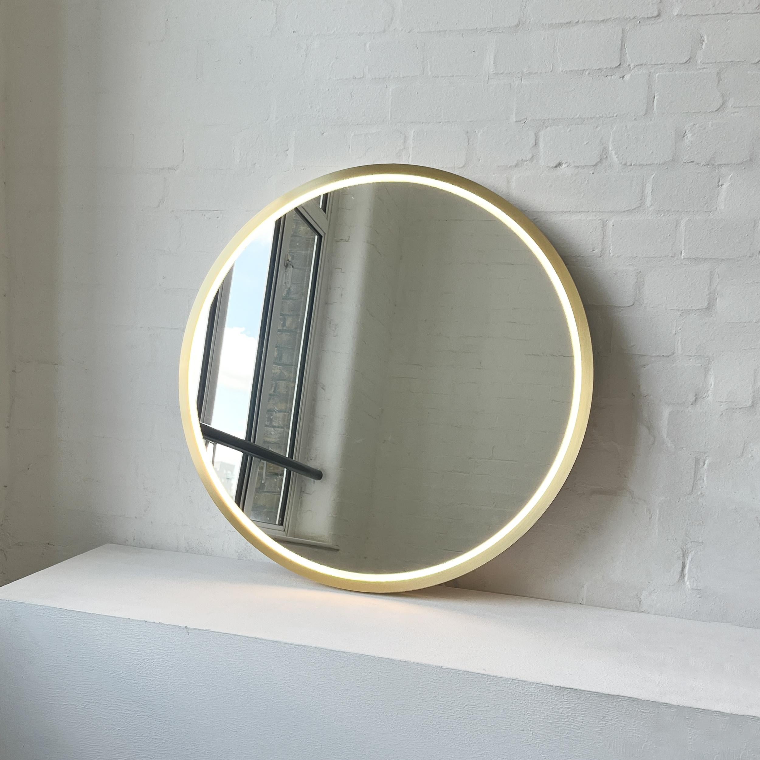 Modern Orbis™ round mirror with front illumination and a solid brushed brass full frame. Designed and made in London, UK. This mirror is fully customisable.

Dimensions: Diameter 76.2cm x Depth 3.1cm / Diameter 30in x 1.22in

Our 'Full Frame' design