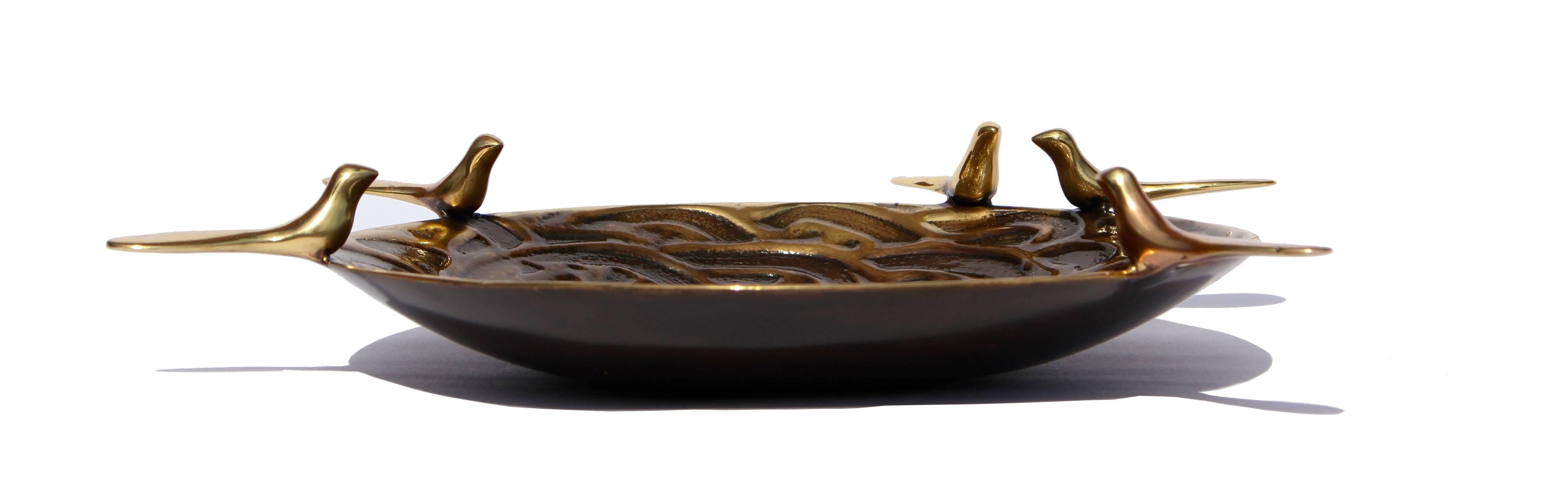 Handmade cast brass dish candle holder with five birds in a bronze patina finish.

Each of those original and elegant dishes are handmade individually. Cast using very traditional techniques, the noble material is aged creating a beautiful
