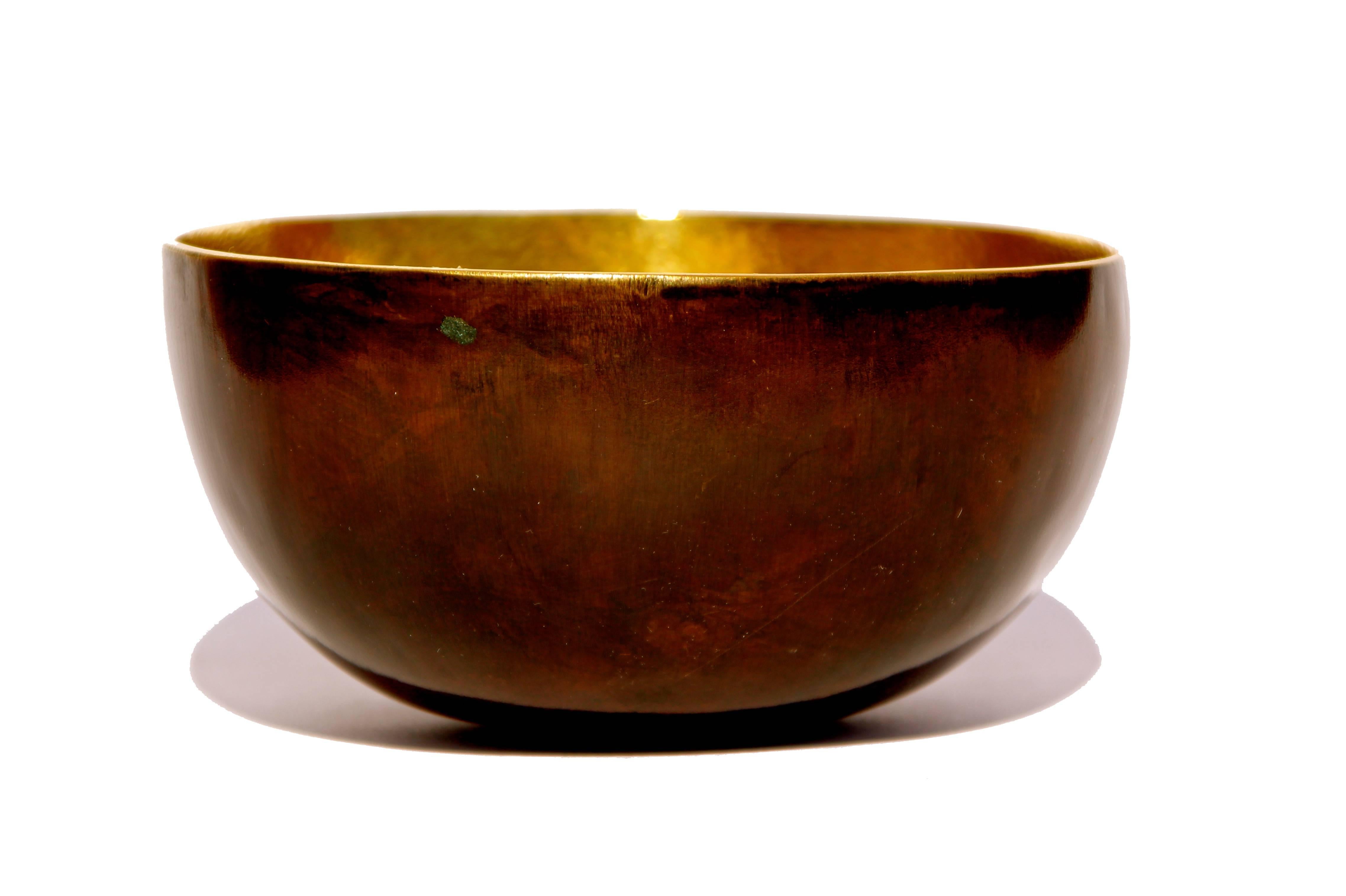 Handmade cast brass small bowl with a bronze patina on the outside and textured polished brass on the inside.

Each of those original and elegant bowls are handmade individually. Cast using very traditional techniques, the noble material is aged