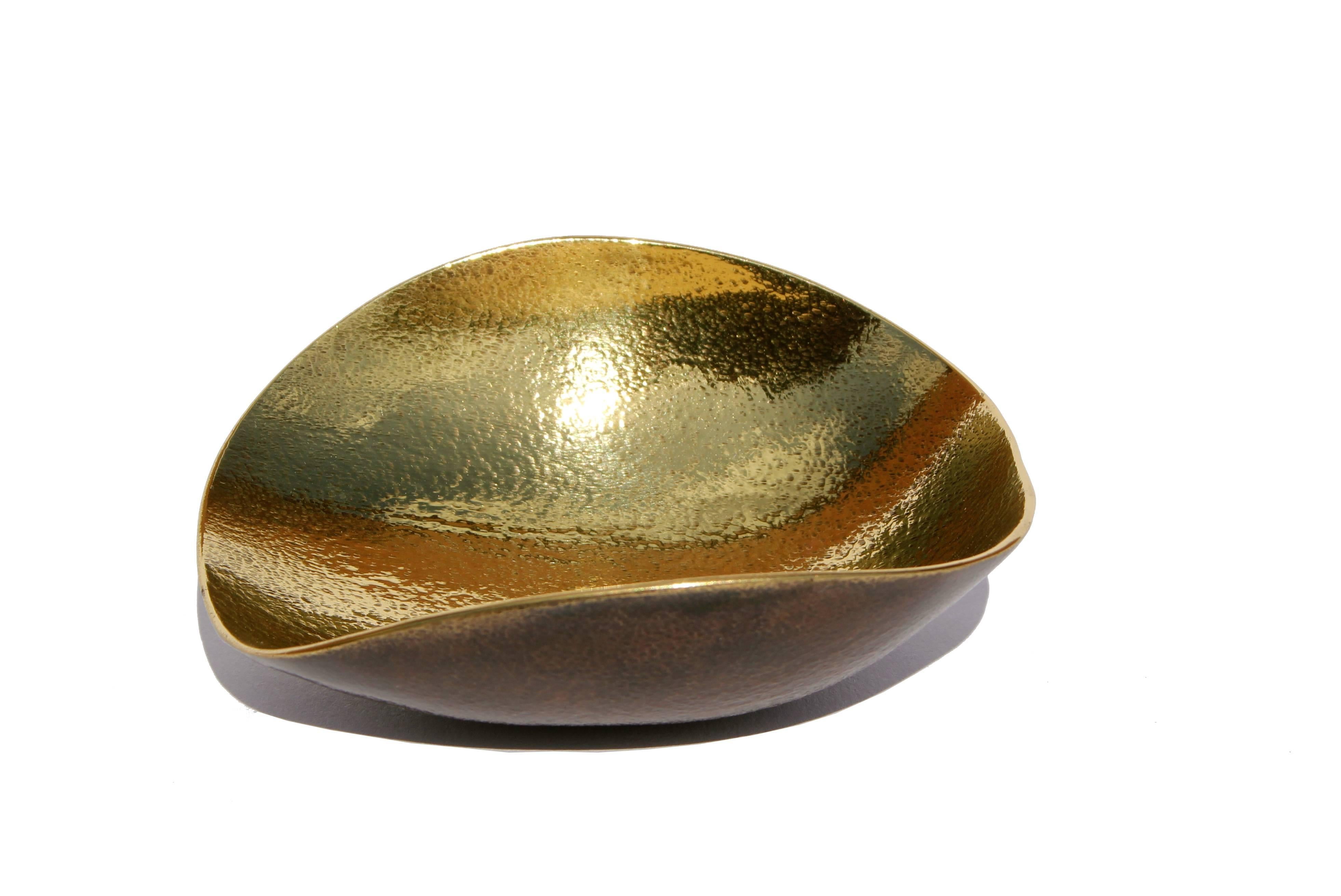 Handmade cast brass shallow bowl with a bronze patina on the outside and textured polished brass on the inside.

Each of those original and elegant bowls are handmade individually. Cast using very traditional techniques, the noble material is aged