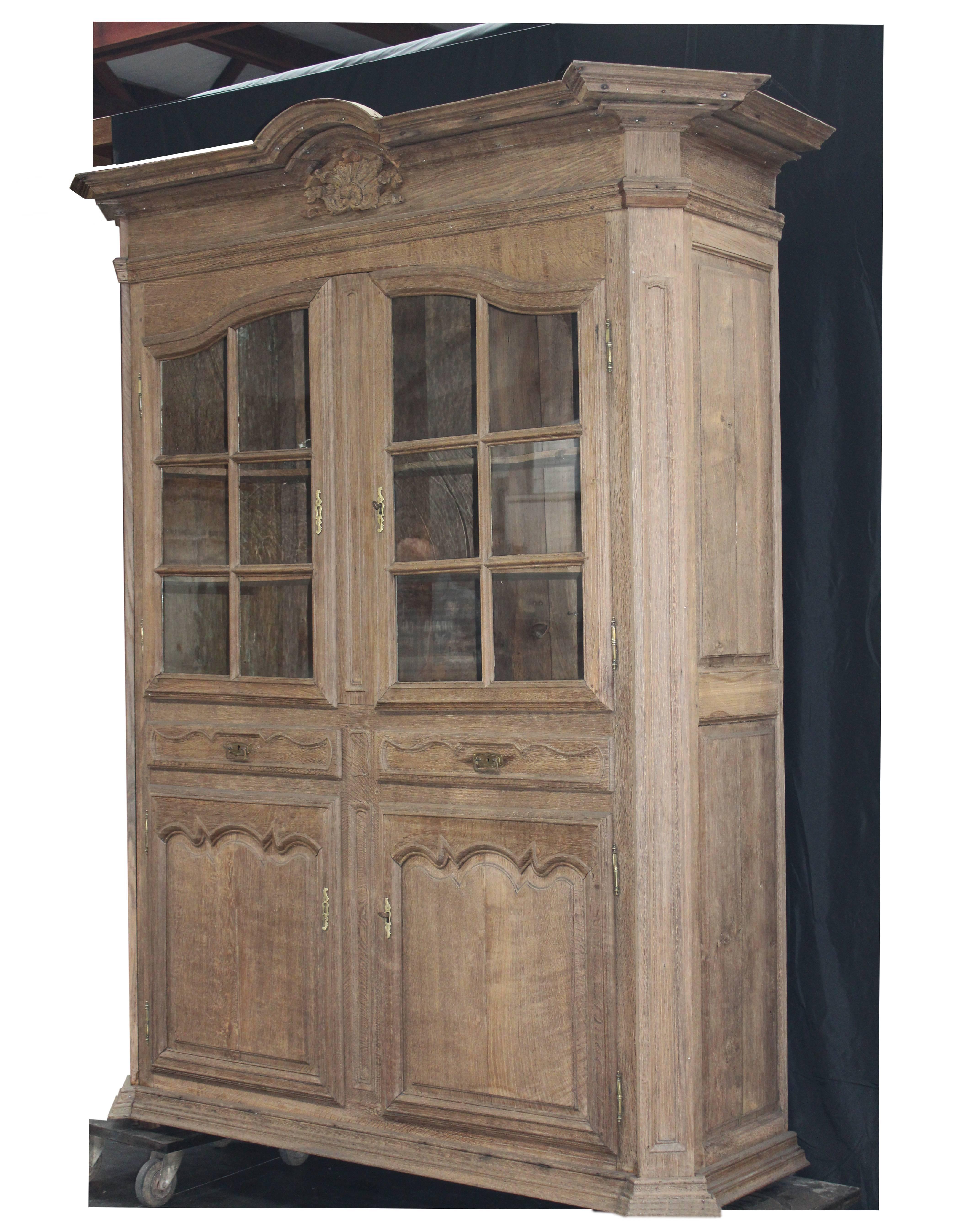 This is a Impressive tall glascabinet in bleached oak, Coms from a Beautiful Castle in Namur,
The cabinet is in a great condition, even with the original old handblown glass in the glasdoors
late 18th century 
nice exceptional quality piece