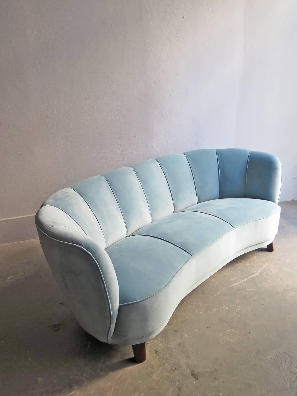 Art Deco blue velvet sofa re-upholstered in wooden legs.