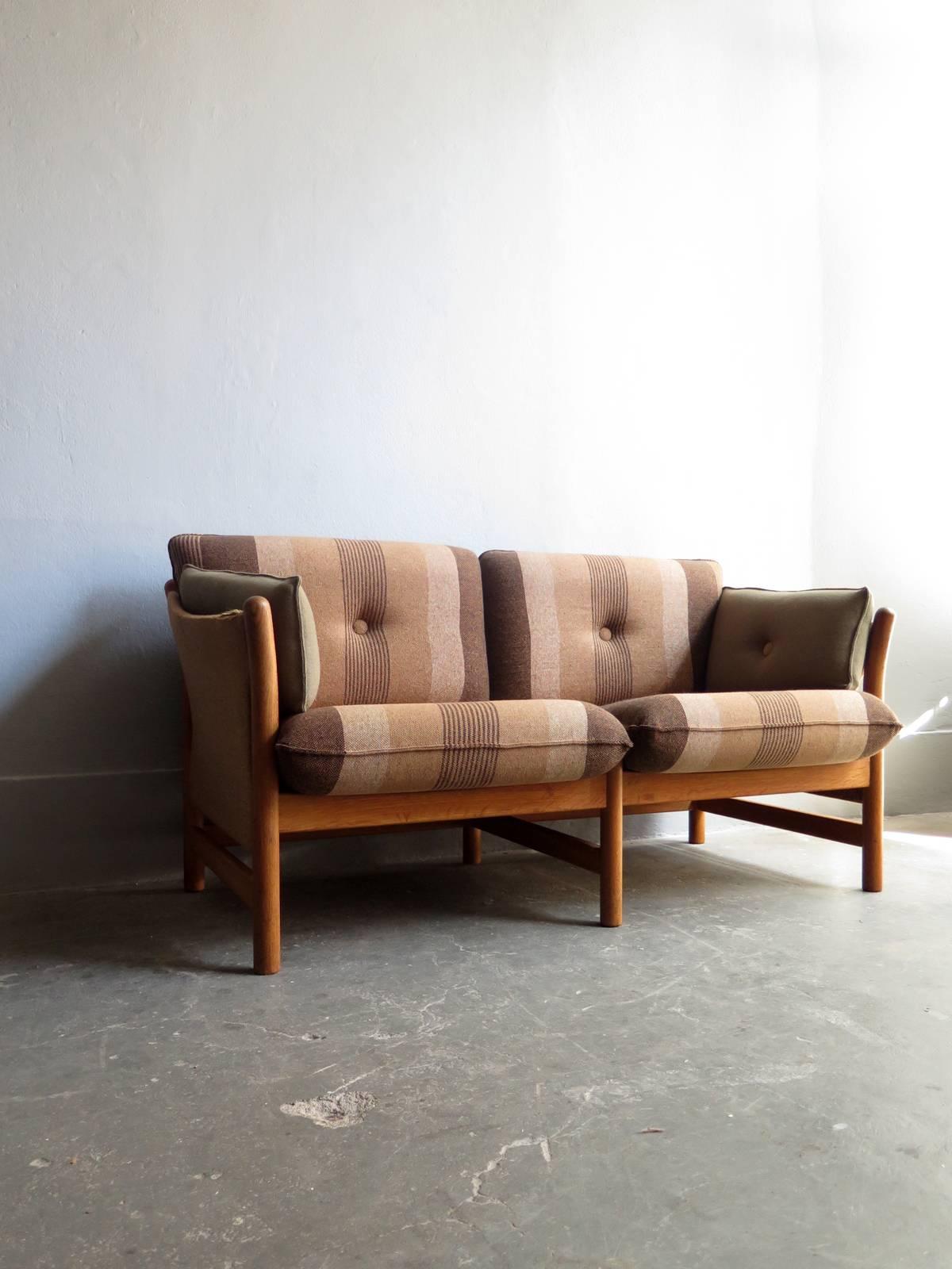Two-seat oak sofa designed by Arne Norell with original fabric.
