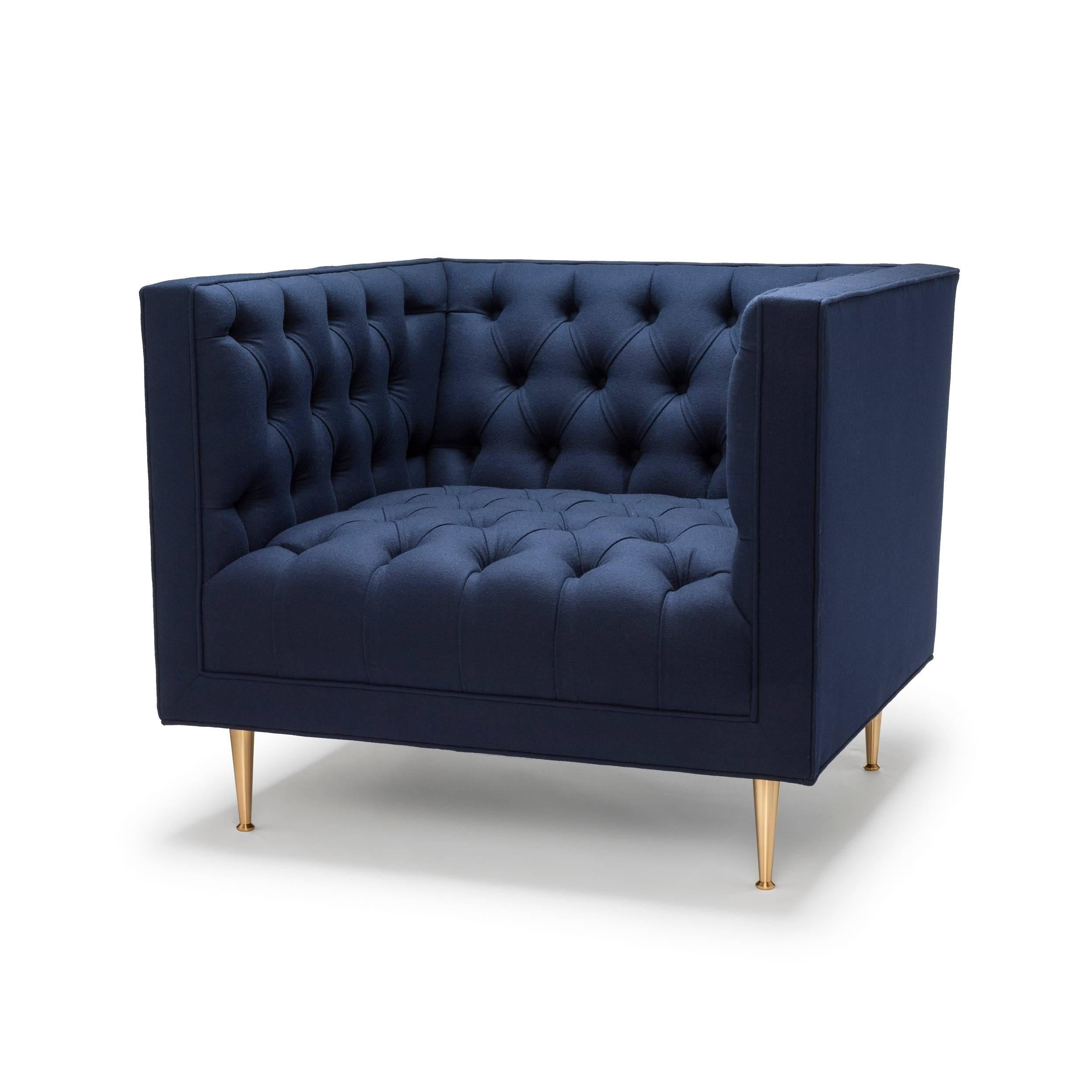 The Tux is our contemporary interpretation of the Classic Chesterfield. The deep buttoning and tailored detailing make this piece a personal favourite. Tux Chair Special Edition shown here upholstered in Navy Melton Wool with legs in natural brass.