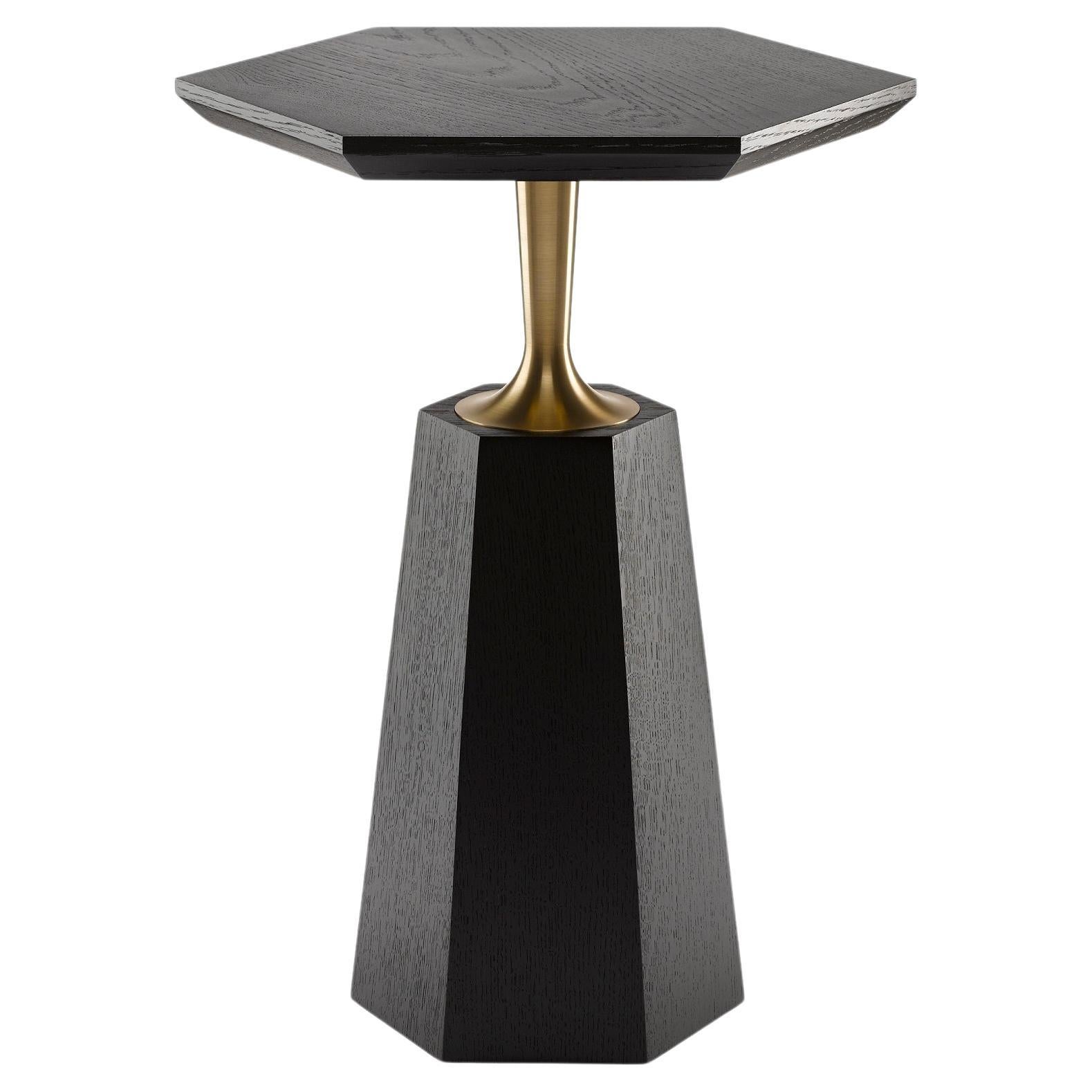 The Hex Side Table has a hexagonal tapering base giving rise to a precision engineered brass neck that supports either a round or hexagonal top. Shown here: in ebonised oak and machine turned solid brass. The brass is available in either a natural