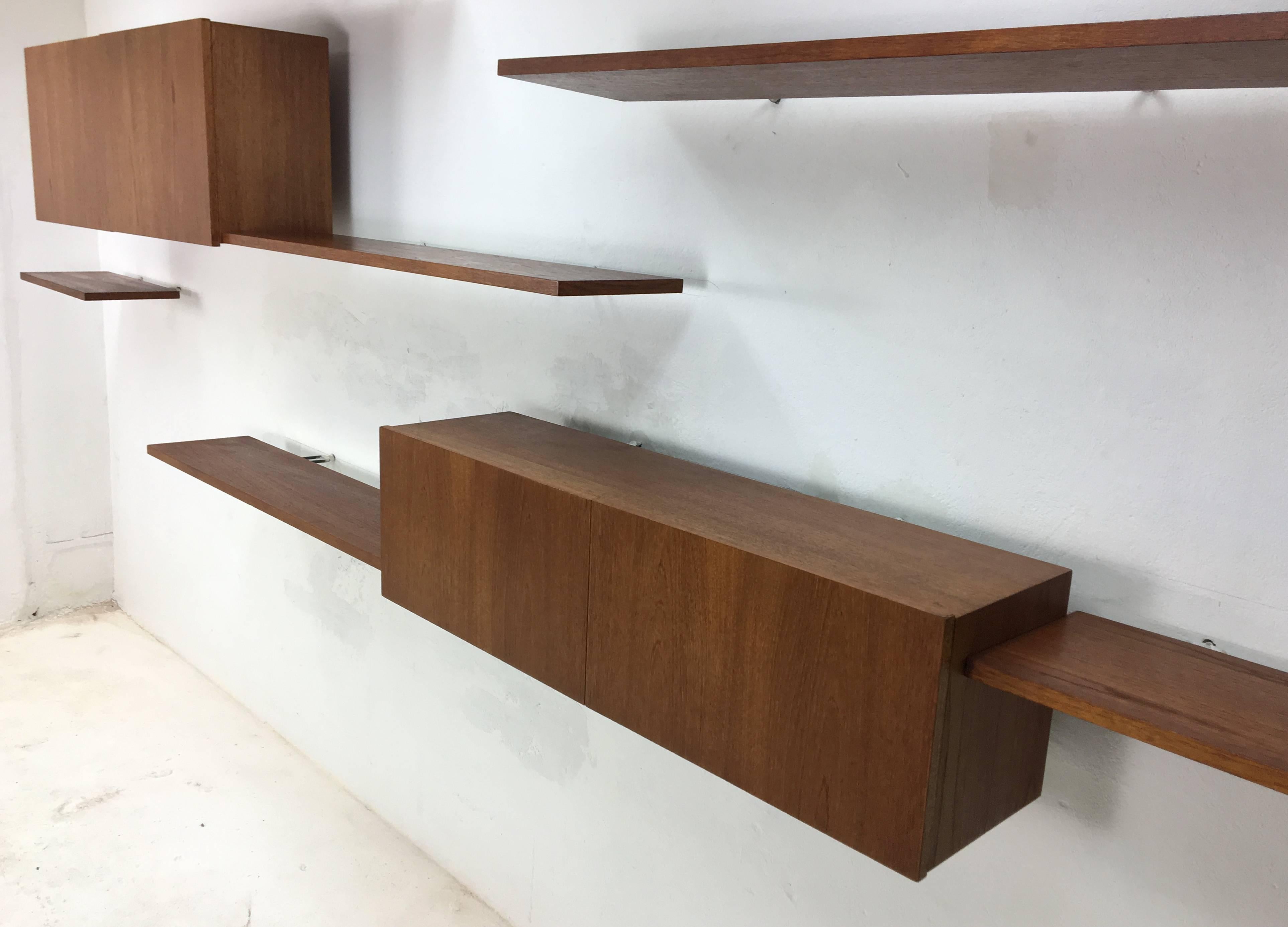 Eight piece floating wall system from German floating furniture specialists Banz Bord. Rosewood on Banz Bord's trademark invisible steel wall mounts.

This system consists of the following parts:

Three x large shelf, 100 x 23cm
Threex small