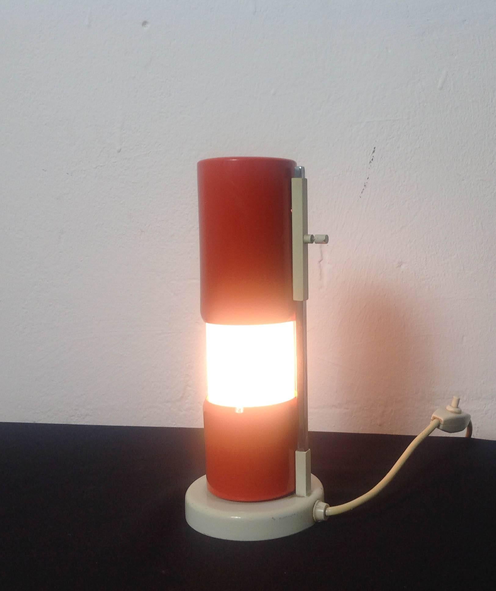 Whimsical small table or desk lamp. Schuivertje ('little slider') was originally designed in the 1930s and reintroduced as part of the GISO line in the 1960s. The top of the metal tube slides up to reveal the light inside, hence the name. This is