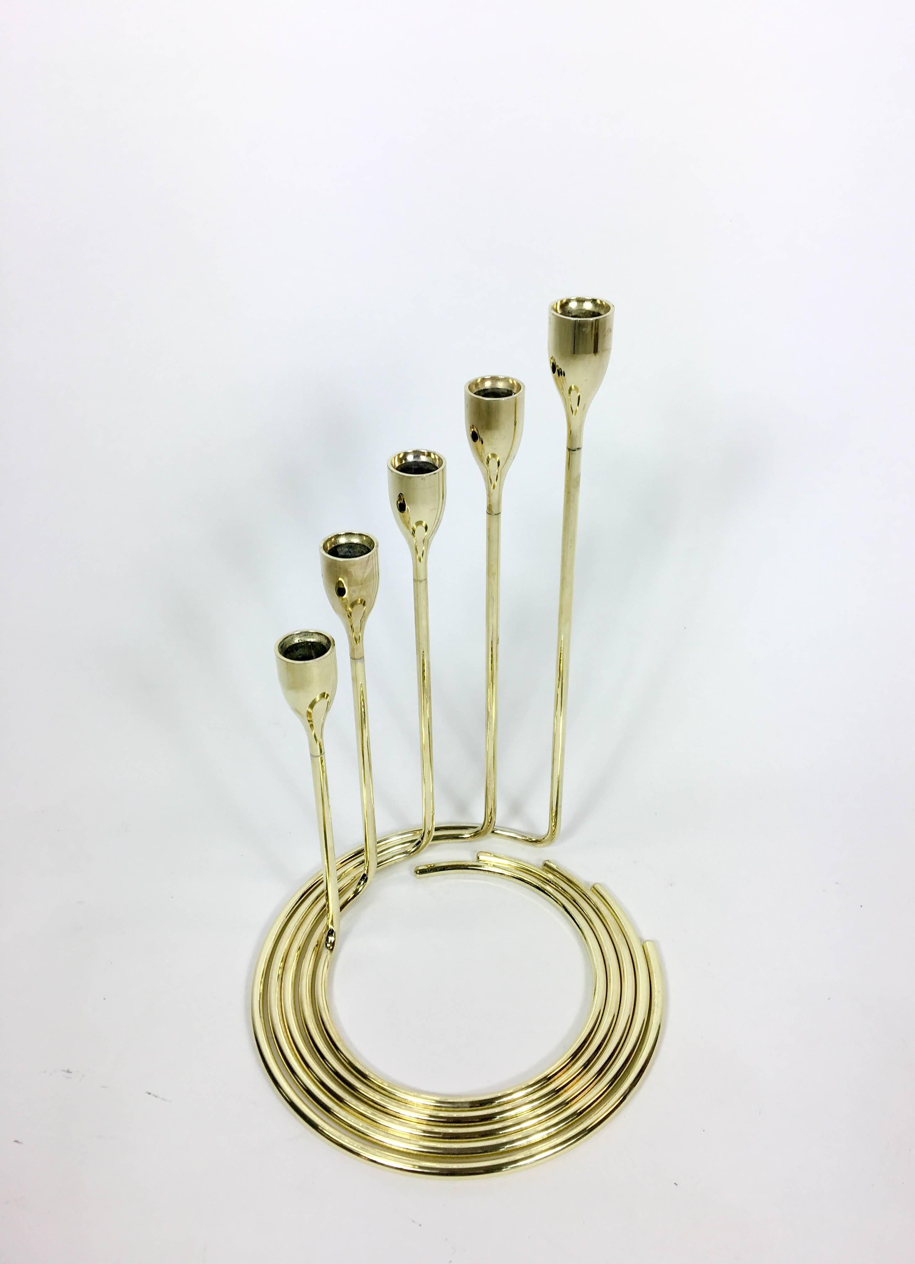 Danish spiral candelabra set. Five separate candlesticks holders with spiral bases that fit neatly together to form a spiral candelabra. Solid brass, 1960s.