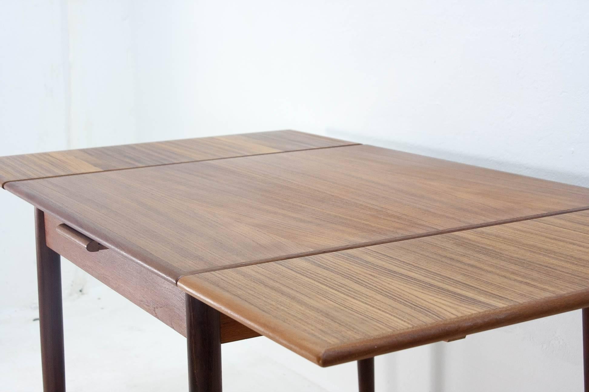 Beautiful Scandinavian extendable dining table from the 1960s. This walnut table is in excellent condition and extends on two sides. The legs are detachable for storage or transport.