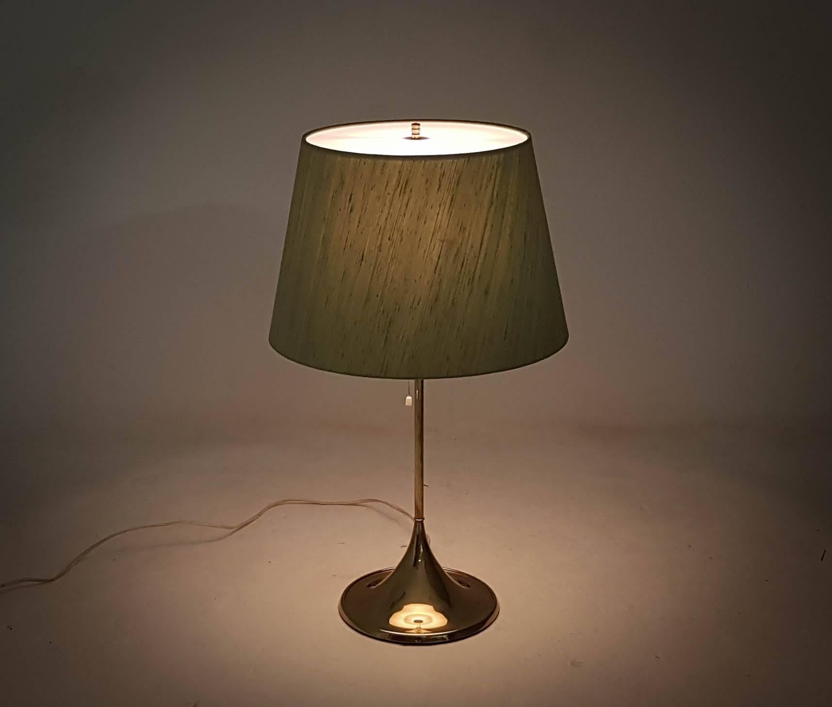Table version of the iconic Bergbom design. Cast iron base finished in brass with an opaque white perspex top on the lampshade. Very nice condition.