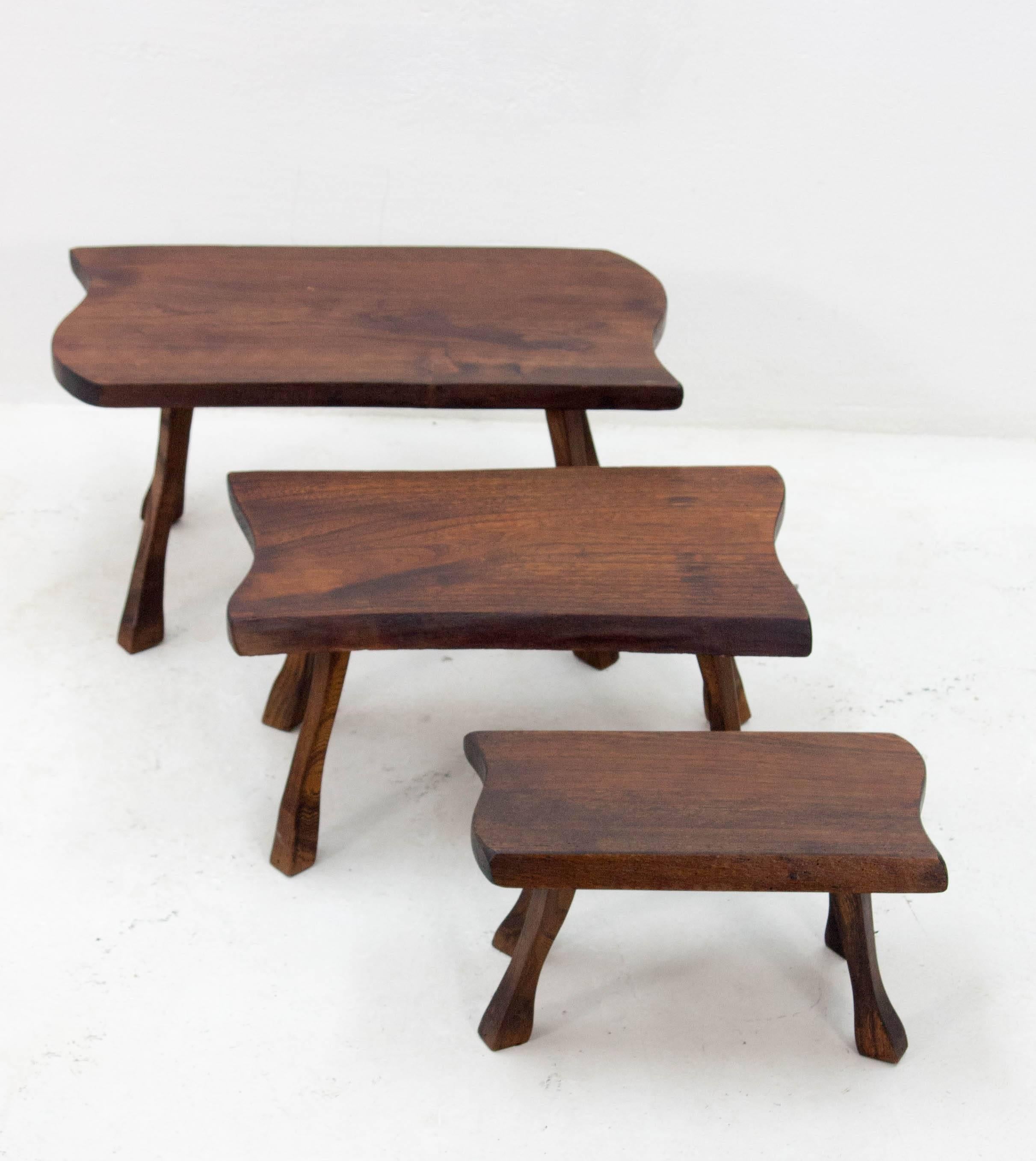 A charming trio of robust tree trunk slab nesting tables on tree branch legs.

Measurements are as follows:

Large table: 
29cm D x 56cm W x 30cm H

Medium table:
25 D x 45 W x 25 H

Small table:
19 D x 35 W x 20 H.


