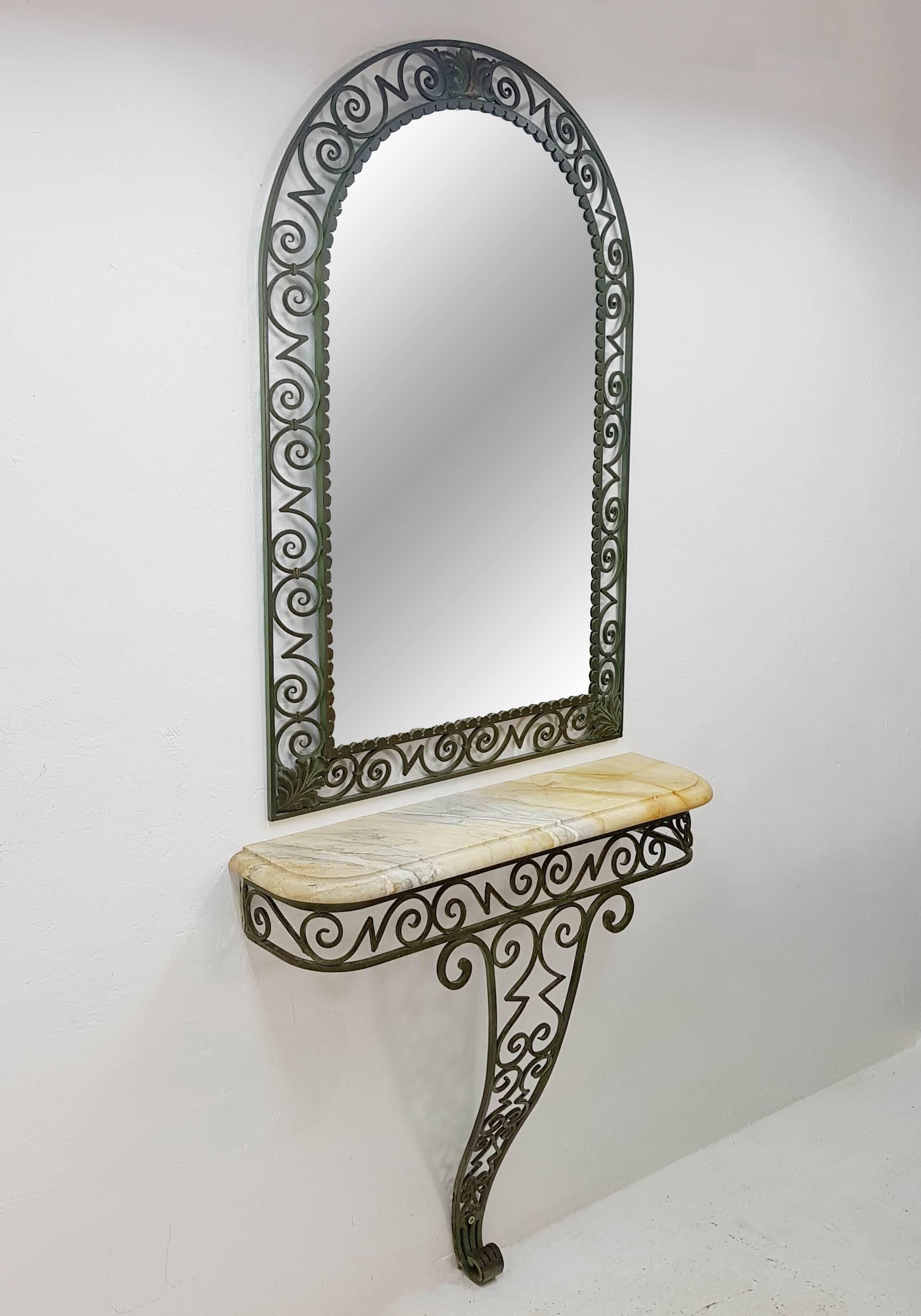 Graceful bronze  Art Deco mirror and console set with a marble surface. The console mounts to a wall which makes it appear to float. France, 1930s.

The console part is 83cm tall, 85cm wide and 23cm deep and the mirror is 112cm high, 72cm wide and