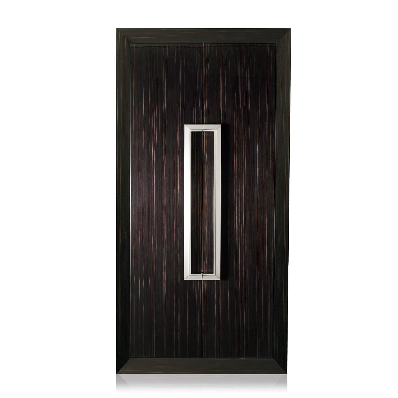 Tempo Assoluto is contemporary and luxurious armoire safe in polished ebony with safe, anchorable to the wall. 
Biometric opening device and emergency key system. Watch winders entirely made in Switzerland. Secret compartment, inside lined in