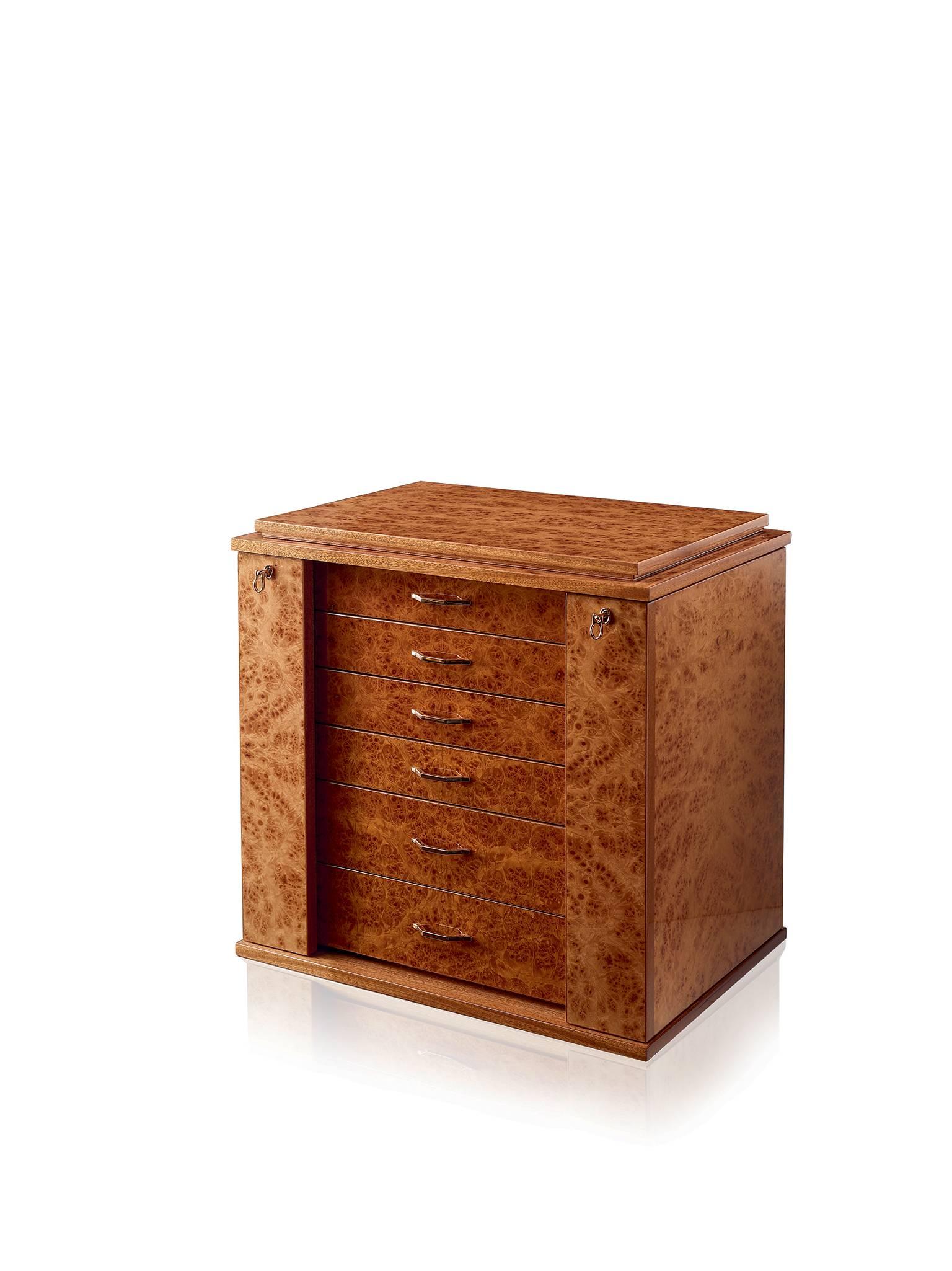 Jewelry chest in polished briarwood and mahogany, ultrasuede lining, 24-karats gold plated brass accessories. With necklace bars, lockable doors and five drawers. Adjustable mirror on the top section.