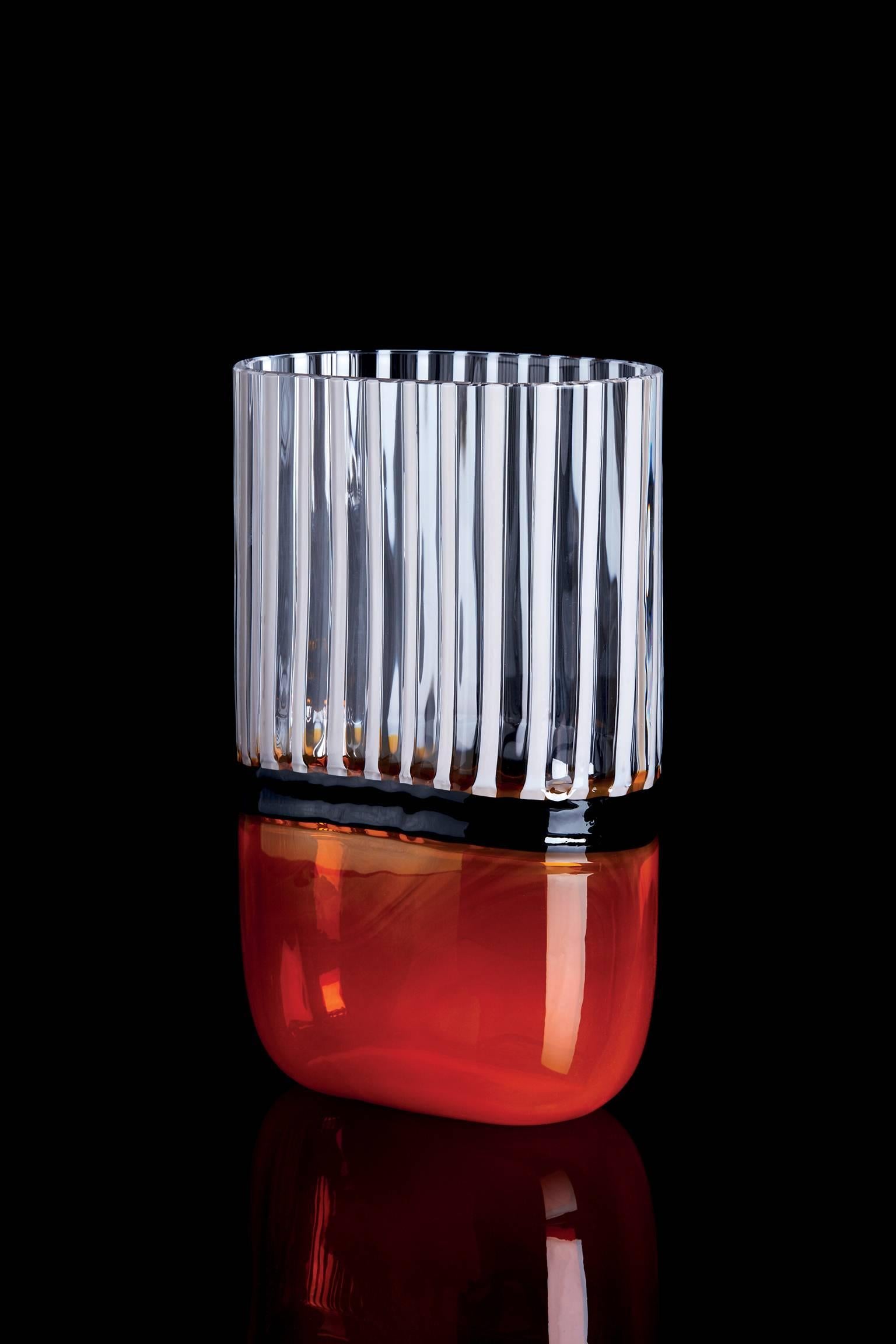 Carlo Moretti Naran contemporary mouth blown Murano glass vase in clear glass with orange, white and blood red details.

Part of the I Piccoli collection, the objects are small in size but give considerable cause for reflection, small but precious.