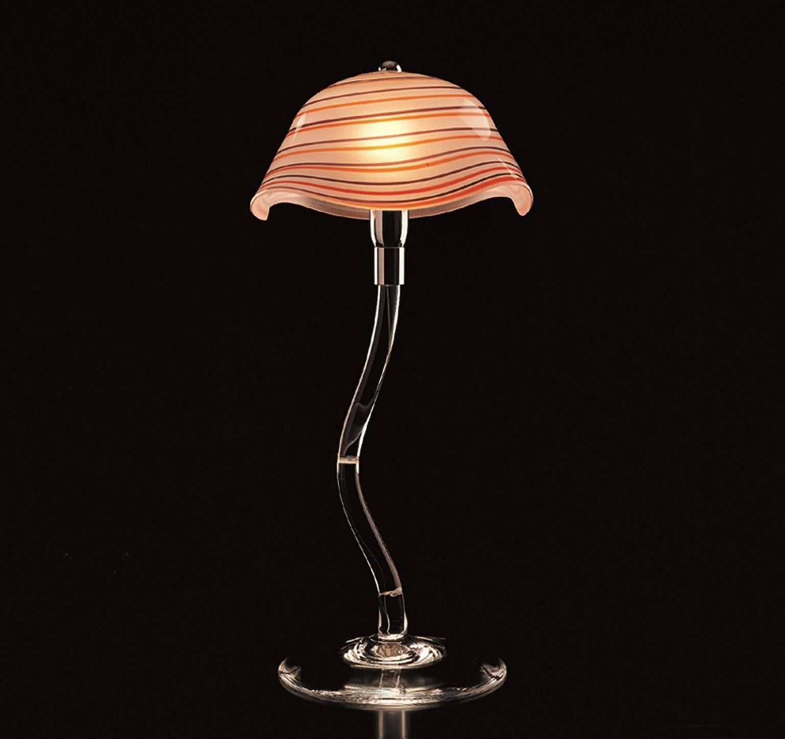 Table lamp with rod and base in transparent Murano glass. Satin glass shade made with a freehand technique and spirals in two different colors. The lamp was designed by Carlo Moretti in 1996. 

40 watt incandescent bulb, 28 watt ecolamp socket