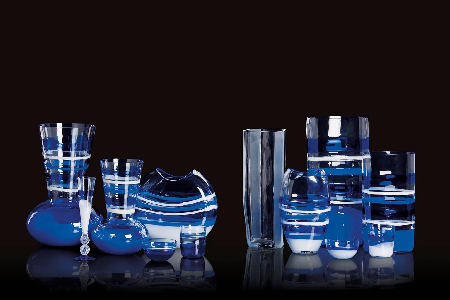 Arco Carlo Moretti contemporary Murano mouth blown glass vase in blue, white and clear glass.

Carlo Moretti: An artisan factory

Strolling afoot through the foundations of Murano, the visitor provided with refined sensitivity, lost in a myriad