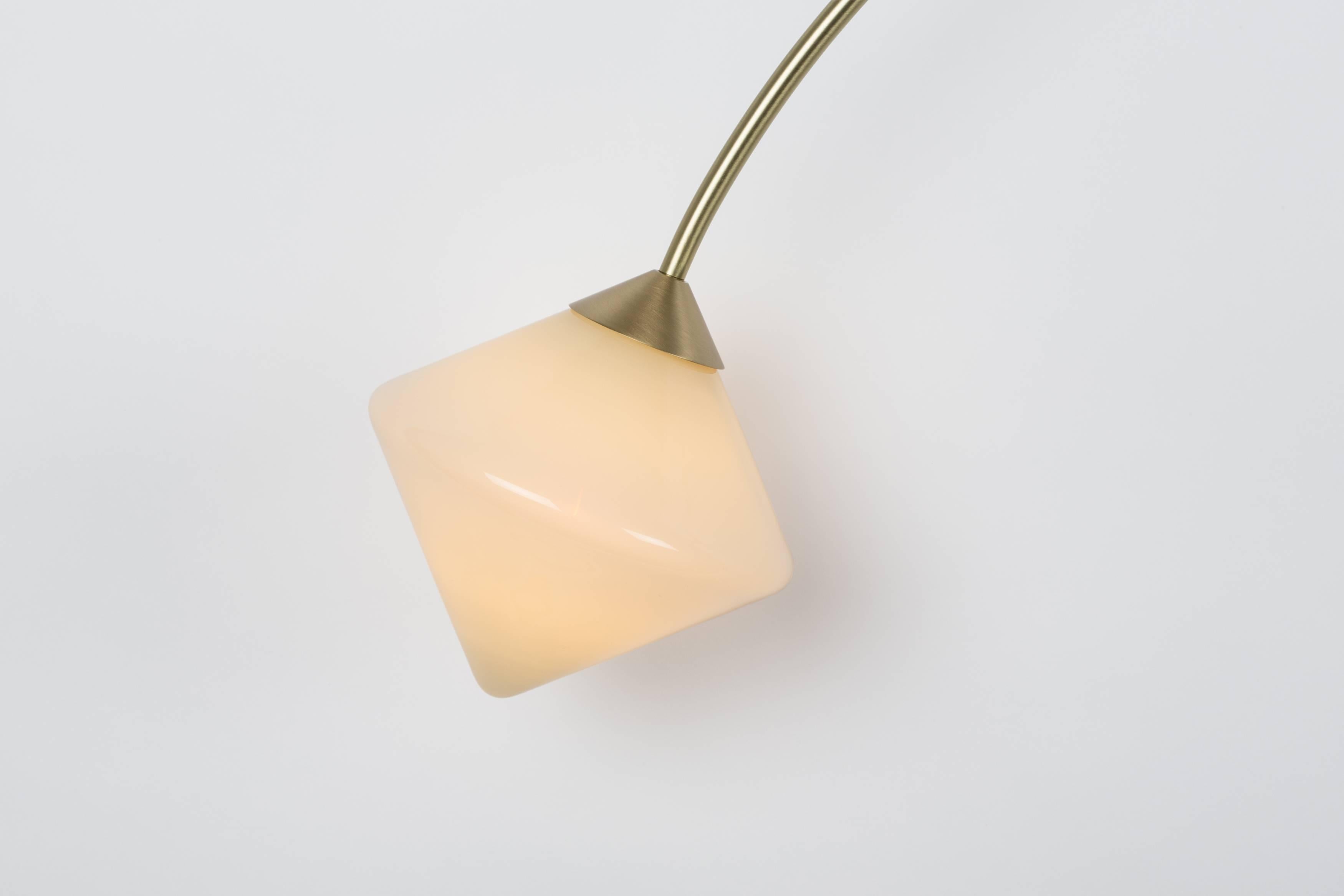 Originally inspired by Victorian balancing toys, Themis combines handblown glass diffusers with an elegant marble and brass bracket to provide a soft glow. The forms are derived from triangular forms manipulated through rotation, mirroring and