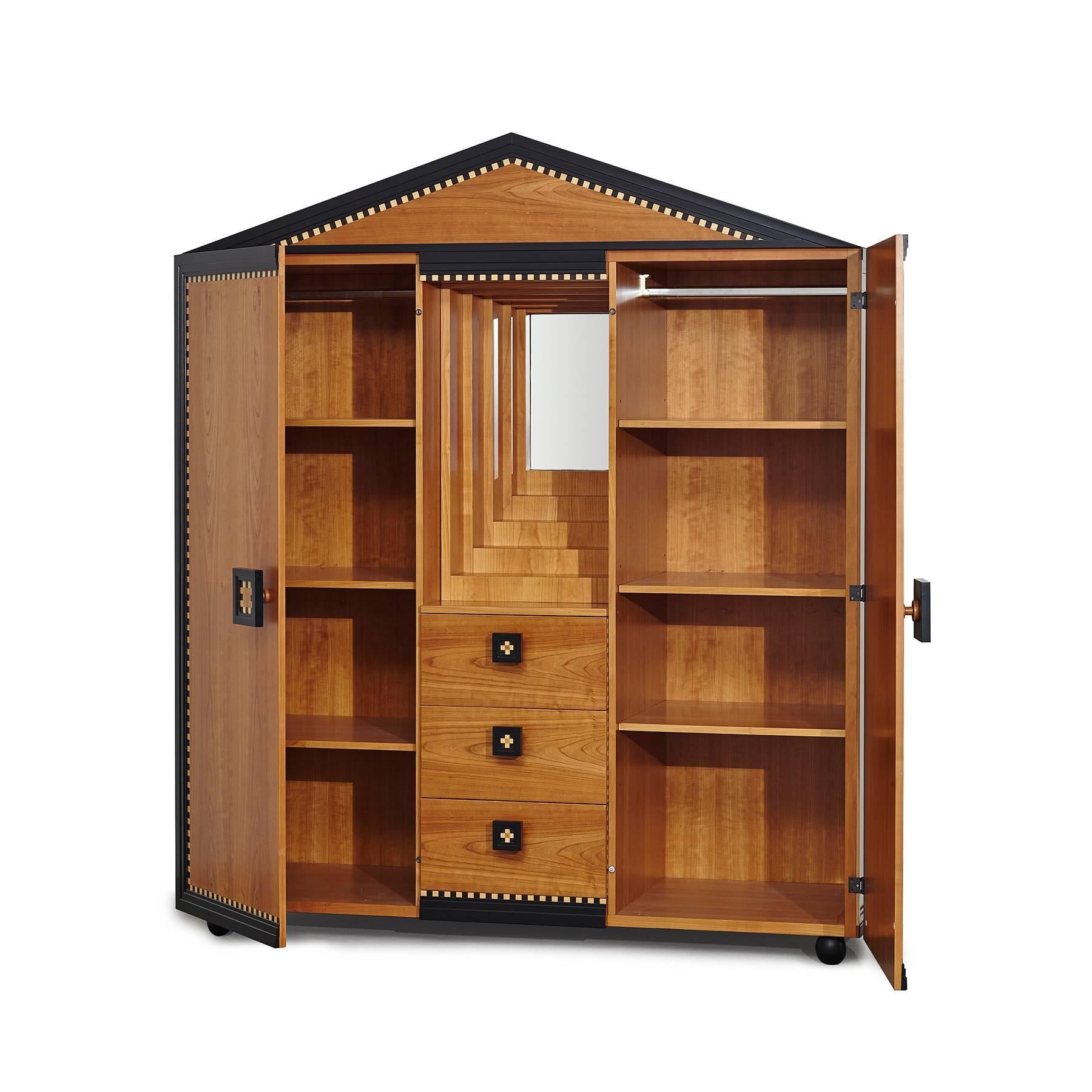 Two-door wardrobe decorated with cherrywood veneer and maple and rosewood inlays. The wardrobe has three central drawers that divide the doors and a recessed mirror. Designed by Paolo Portoghese for Meccani Arredamenti.