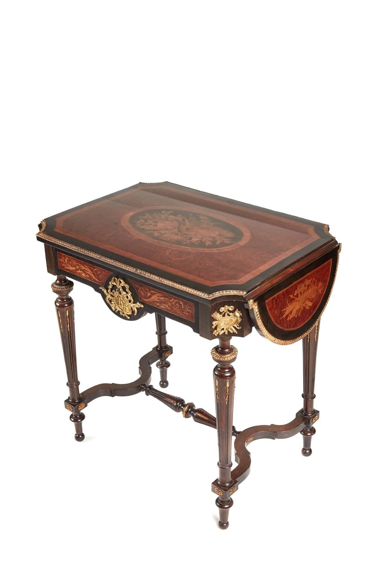 Fine French marquetry drop leaf centre table, with a fine amboyna veneered top and fine marquetry satinwood, walnut, boxwood, kingwood and black lacquer inlay framed within a kingwood and black lacquer banding, the two shaped drop leafs with good
