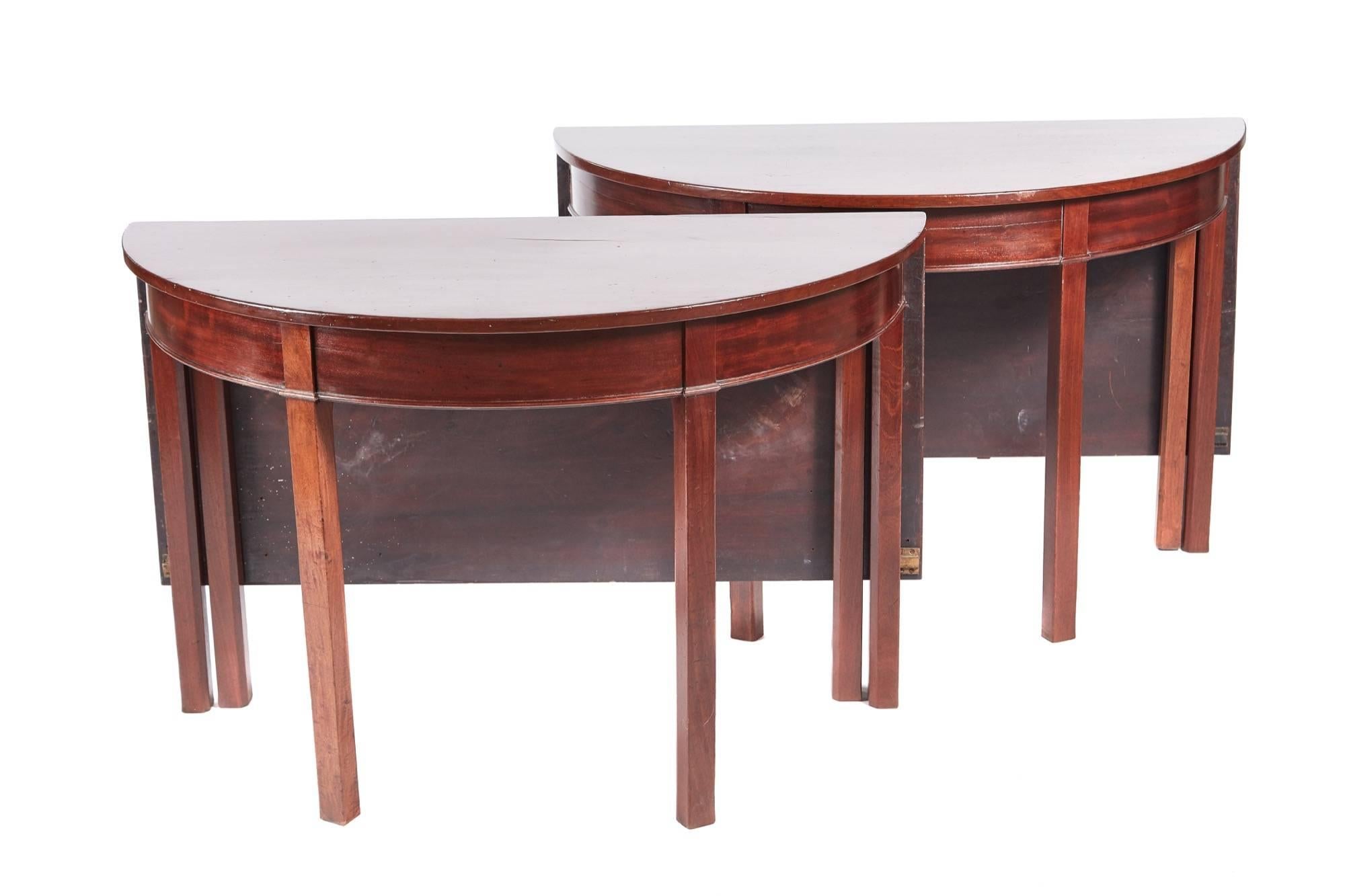 Antique George III mahogany dining table, unusual pair of d-end or console tables with drop leaves, lovely solid mahogany top, making a fantastic dining table, standing on 12 square legs
Lovely color and condition.