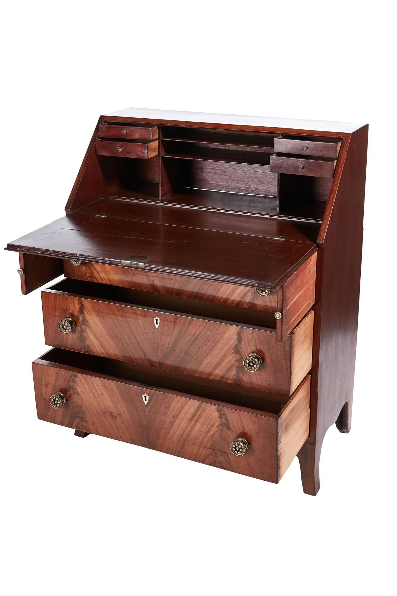 Antique mahogany bureau, having three long drawers with original brass handles, the mahogany cross-banded fall opens to a four-drawer fitted interior, standing on tall slender shaped bracket feet with a serpentine apron.
Lovely color and