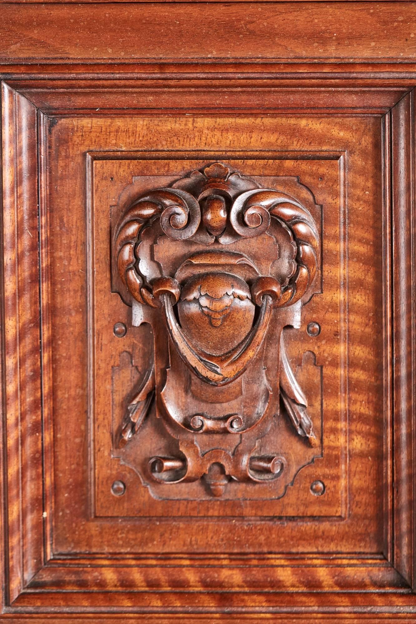 Outstanding carved walnut court cupboard, with a breakfront cornice, supported by two lovely carved solid walnut columns, small carved double door cupboard in the top section, the base with a solid walnut breakfront top. Two fitted drawers with