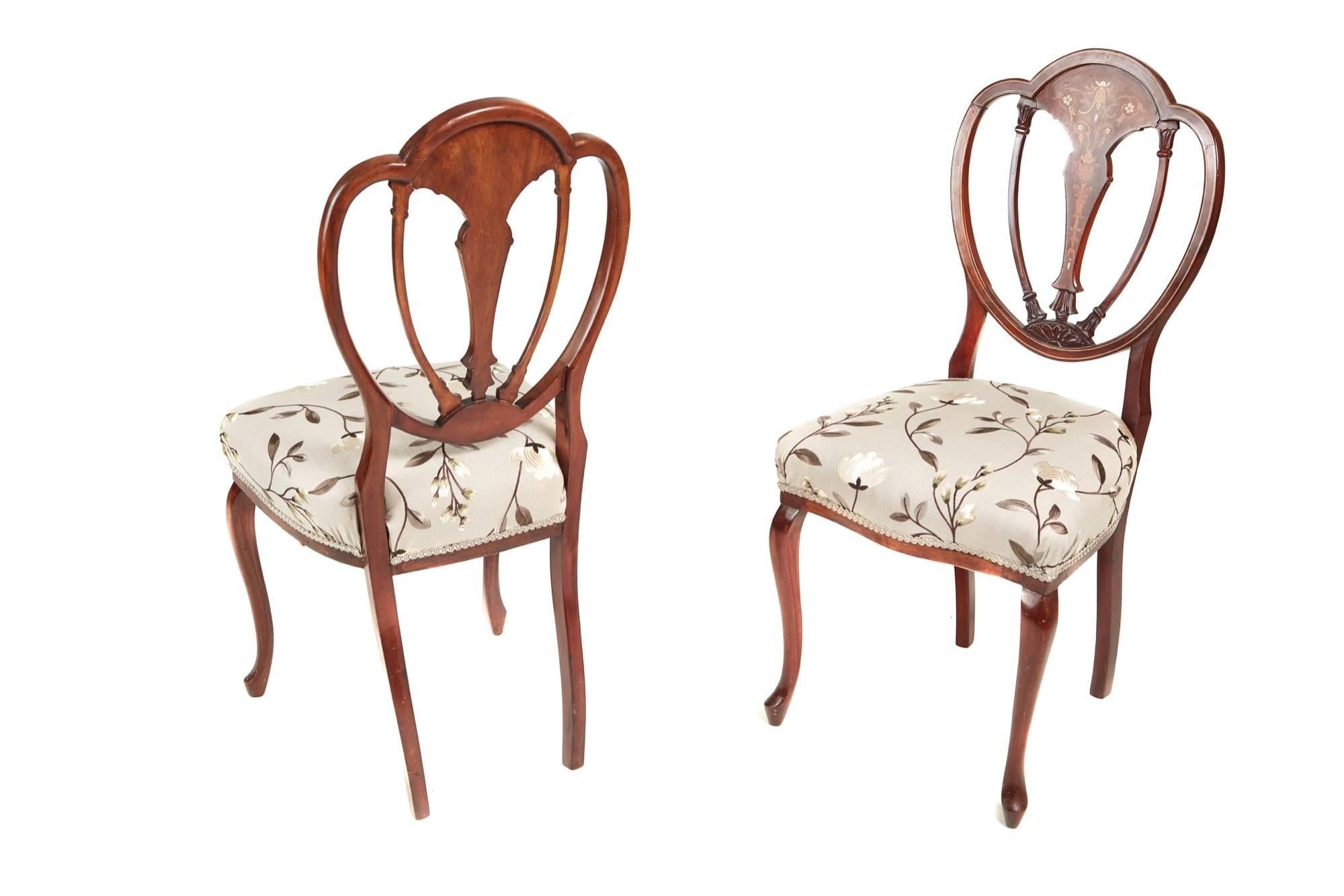 A lovely pair of mahogany inlaid side chairs with a shaped back, marquetry inlaid centre splat, newly re-upholstered seats in a quality fabric, supported by cabriole legs to the front out swept back legs.

Fantastic colour and condition.