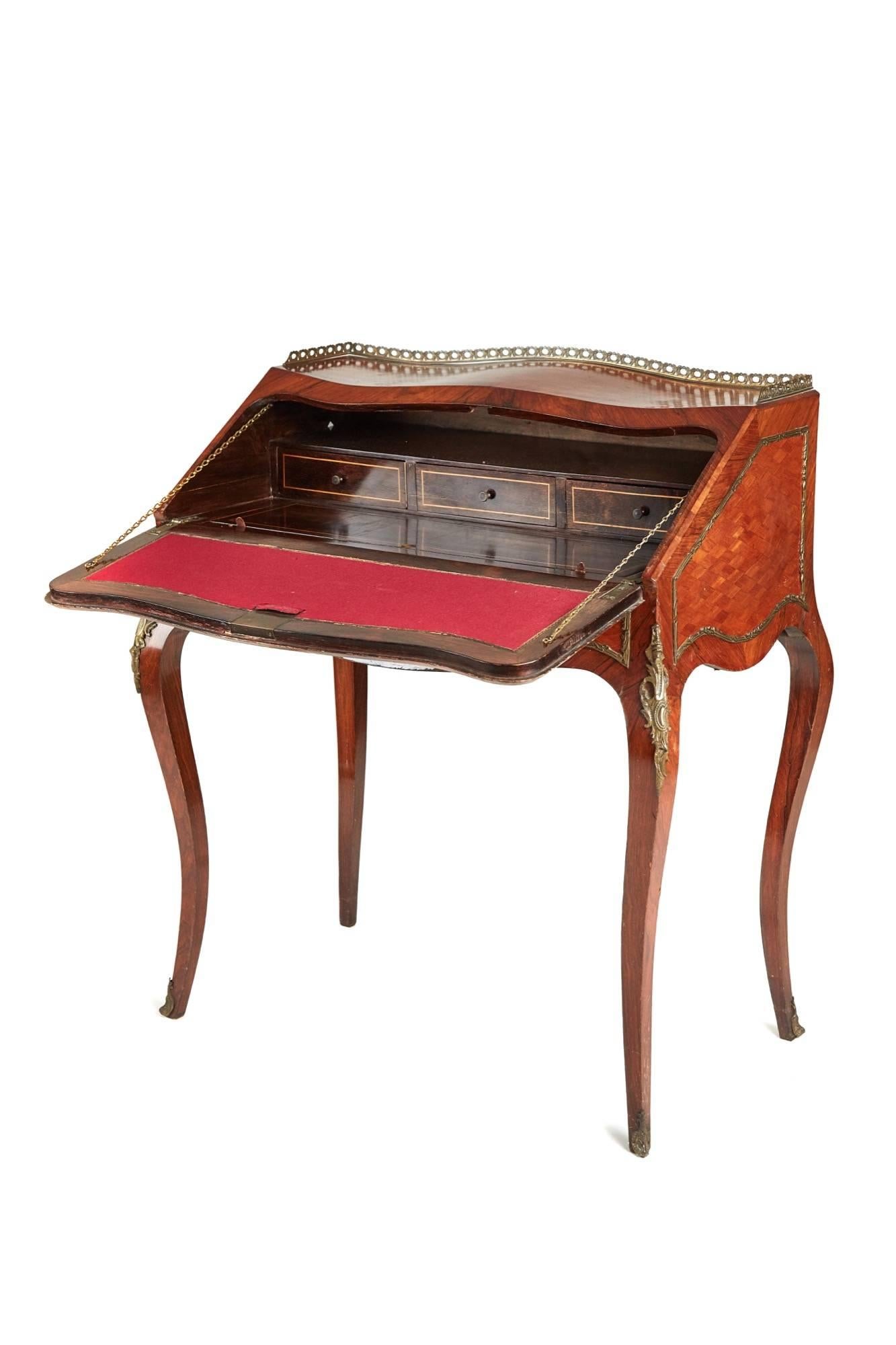 A French kingwood and parquetry bureau de dame with a shaped parquetry top original gilt metal gallery, shaped parquetry ends with gilt metal mounts, lovely shaped vernis martin painted fall crossbanded in kingwood, the inside has a writing surface