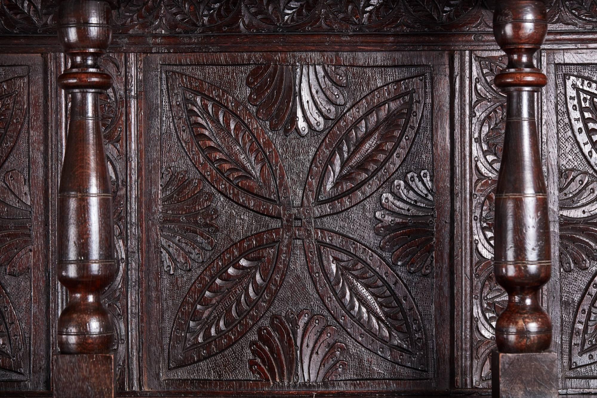 Large antique carved oak dresser, the top section with six wonderful hand-carved panels, two shelves supported by eight turned columns, the base having three hand-carved drawers with original handles, beneath are three hand-carved doors enclosing a