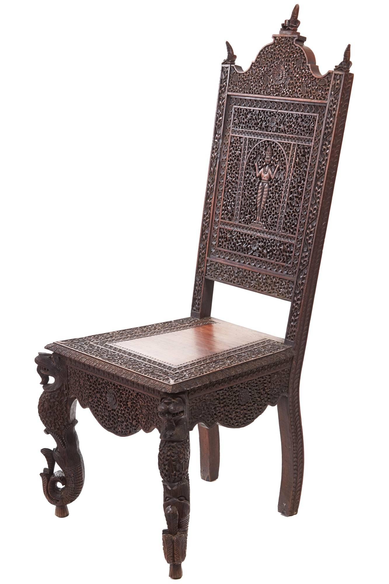 Unusual profusely pierced carved Indian rosewood side chair, the shaped top rail decorated with three seated figures, the back profusely pierced carved with a figure and flowers, lovely pierced carved shaped apron, supported by unusual shaped front