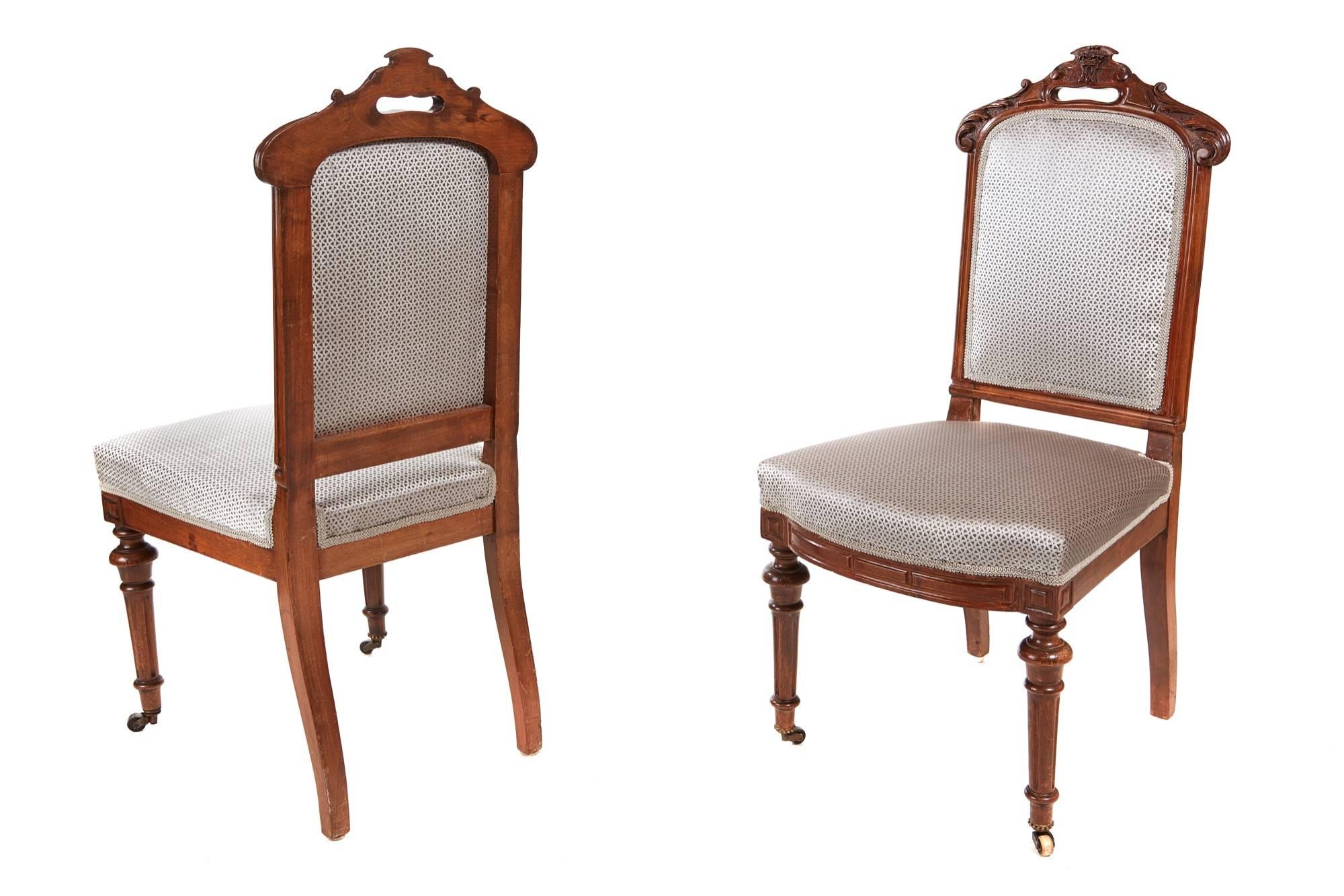 Fine set of eight Victorian carved walnut dining chairs, the quality carved top with a carved crown to the centre, unusual carved monogram with the initials M S, reeded walnut framed with padded backs, overstuffed seats, shaped carved walnut front