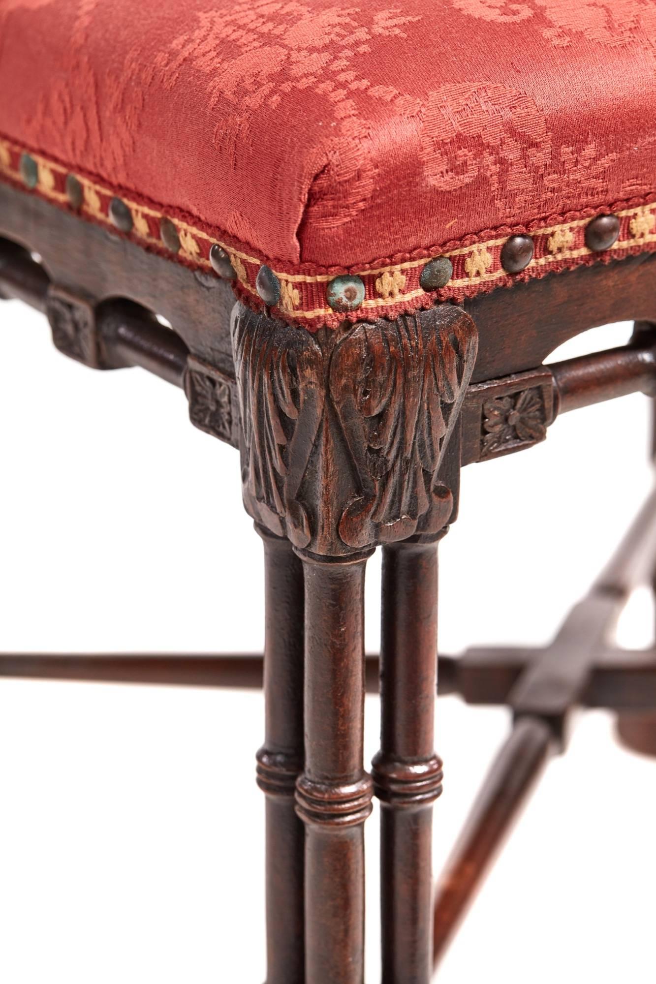 George III mahogany Chinese Chippendale stool, unusual shaped carved and turned frieze, supported by turned and carved cluster columns, united by a turned cross stretcher
Lovely color and condition.