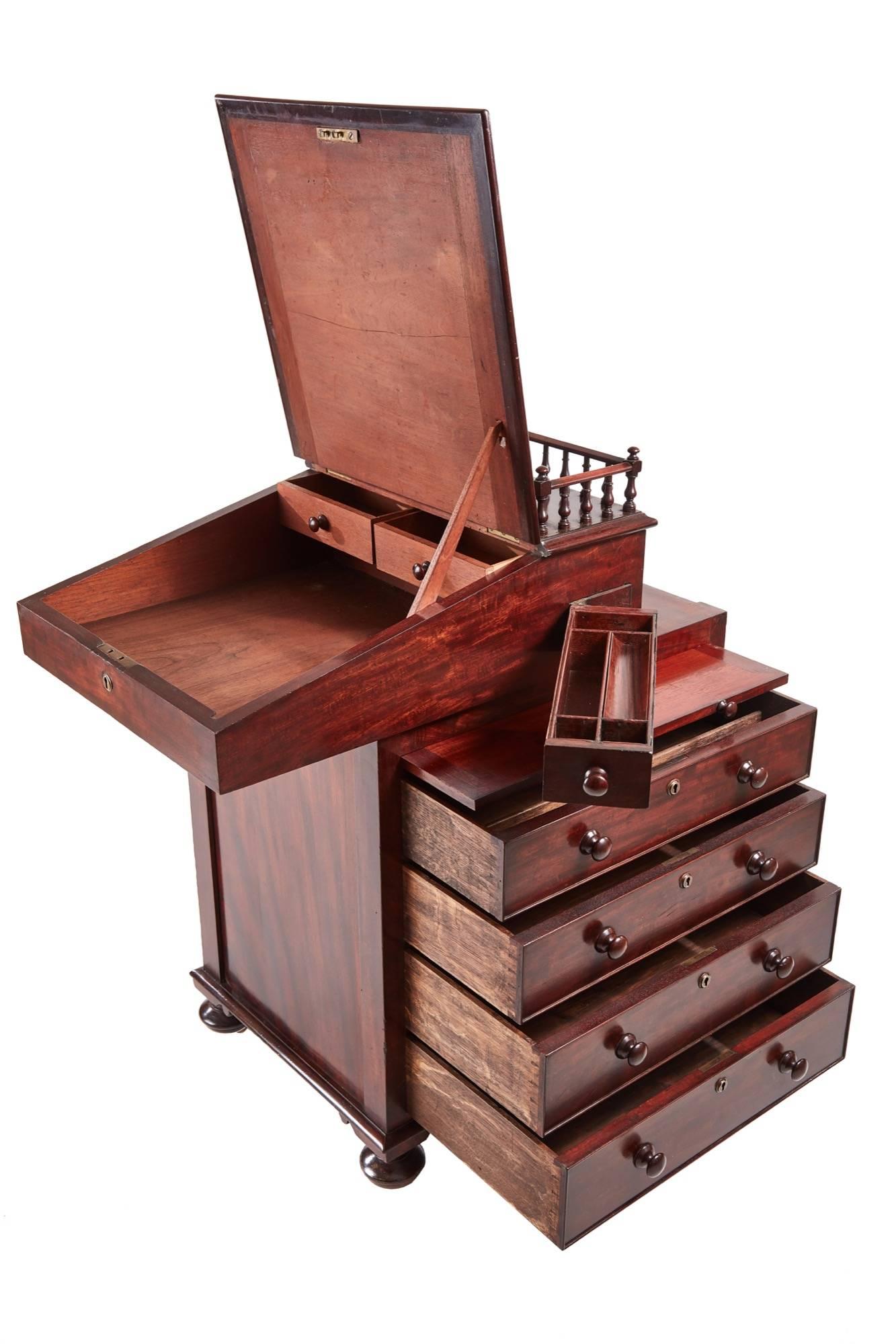 Unusual Regency freestanding mahogany sliding top Davenport, the sliding top with a turned gallery, the leather lined hinged slope with moulded edge opening to an interior of two drawers, the right side having a slide out hinged pen drawer, one