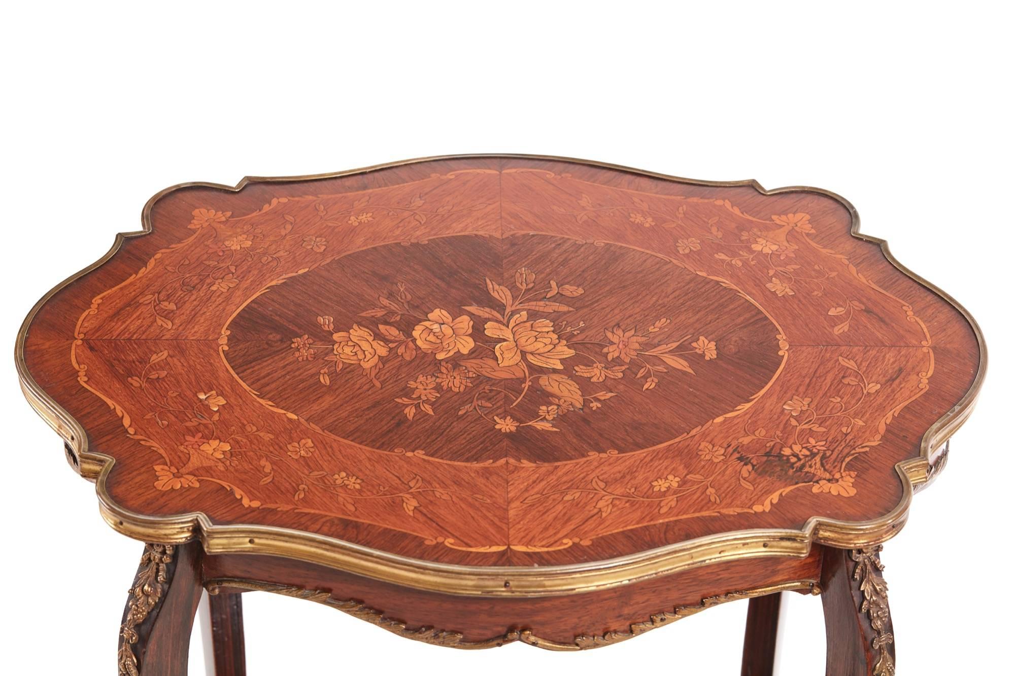Fine French marquetry shaped top occasional table, the tabletop is a mixture of walnut rosewood and kingwood with foliate marquetry to the centre, cast brass moulded banding, the under tier has a brass moulded edge, standing on four shaped legs with