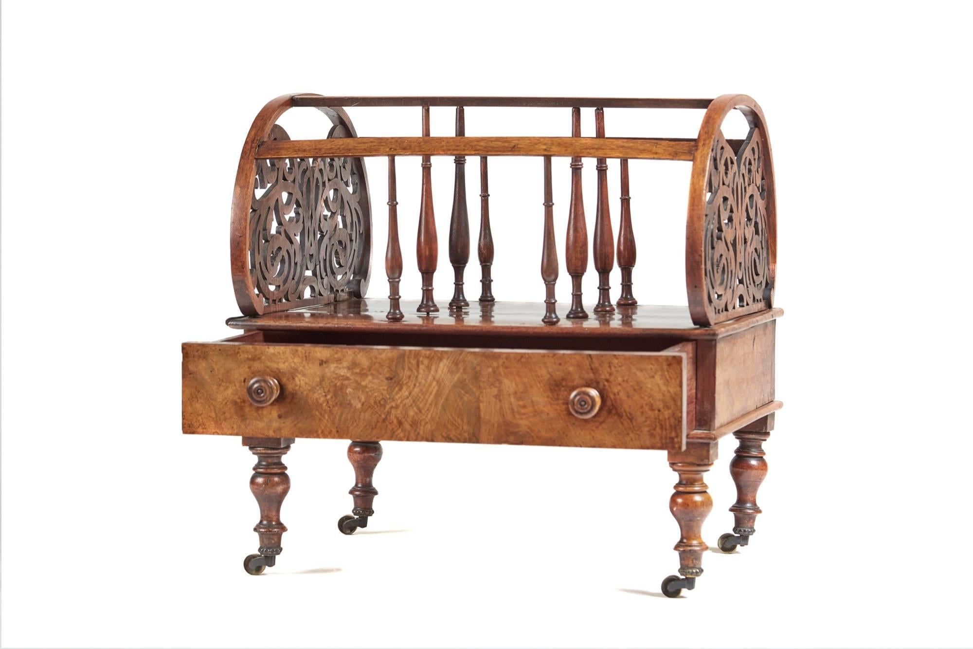 A large Victorian freestanding burr walnut canterbury, oval shaped ends having pierced fretwork with three divisions supported by baluster turned spindles, the base having one long drawer standing on turned solid walnut legs original