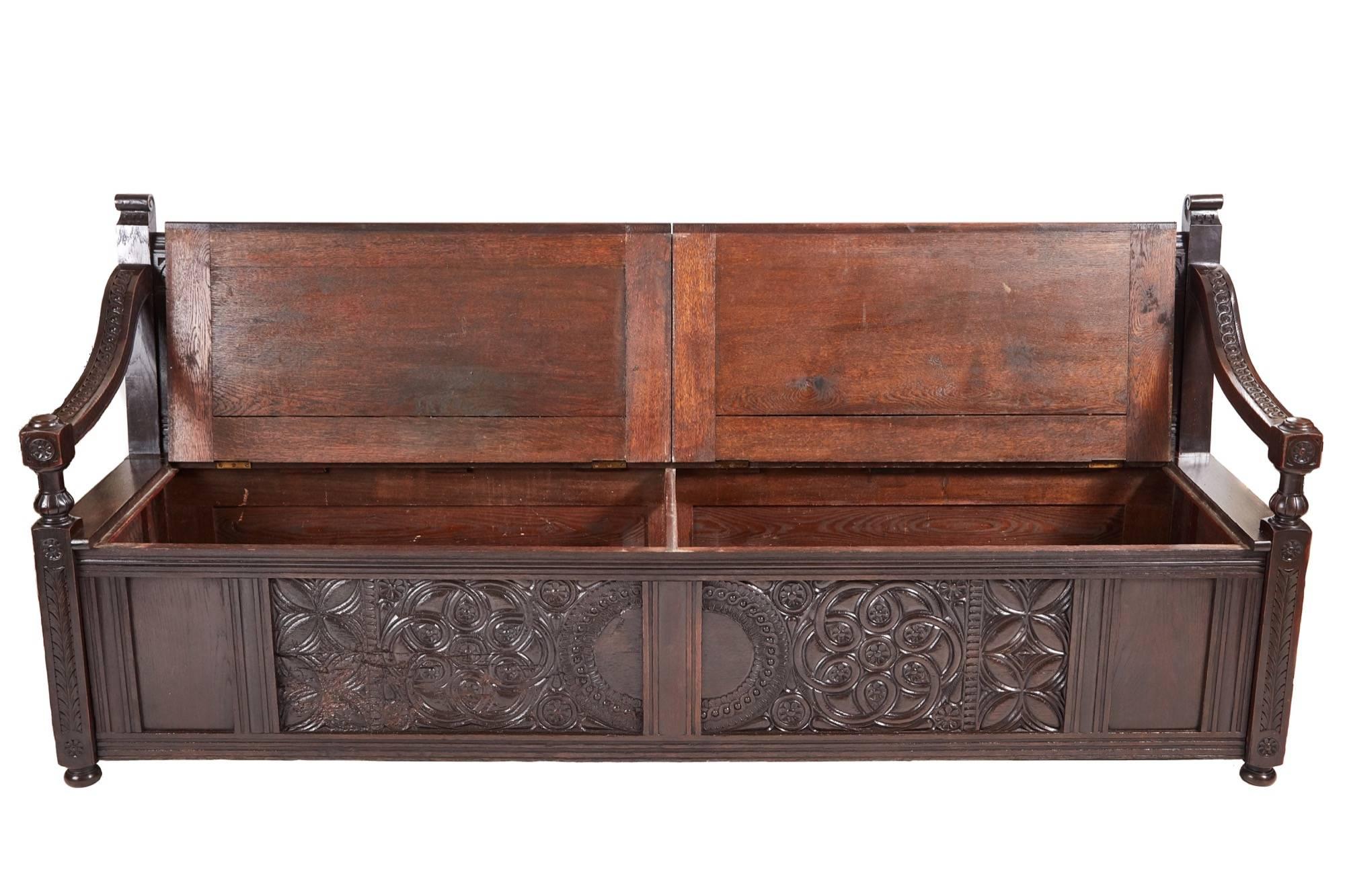 fantastic antique large carved oak storage settle, with three fantastic carved panels to the back, shaped carved arms, two lift up storage seats, two large carved panels to the front, lovely carved ends, standing on short turned feet
Fantastic