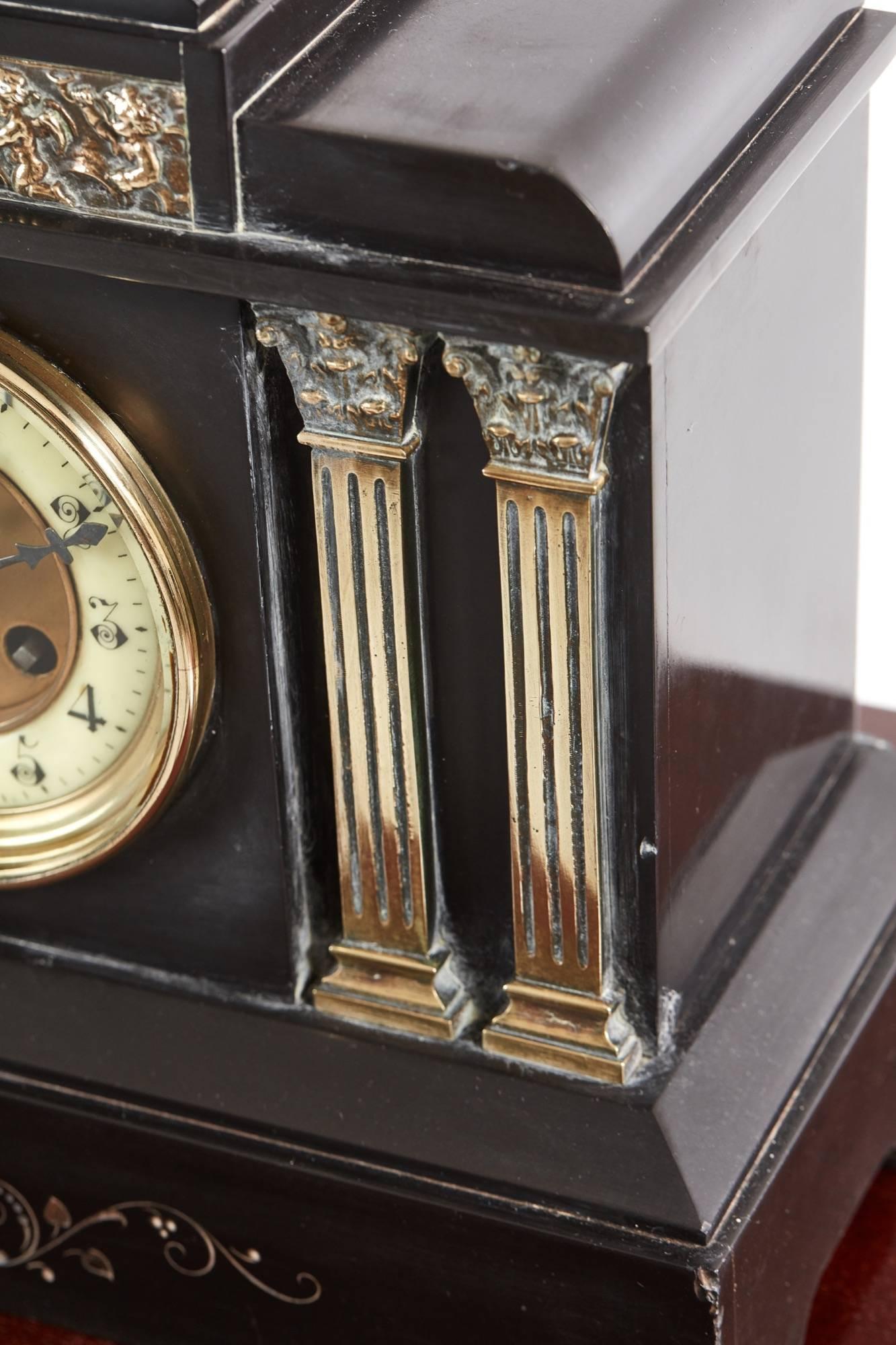 Victorian black marble mantel clock, with ornate solid brass embellishment, eight day movement in good working order, original key.