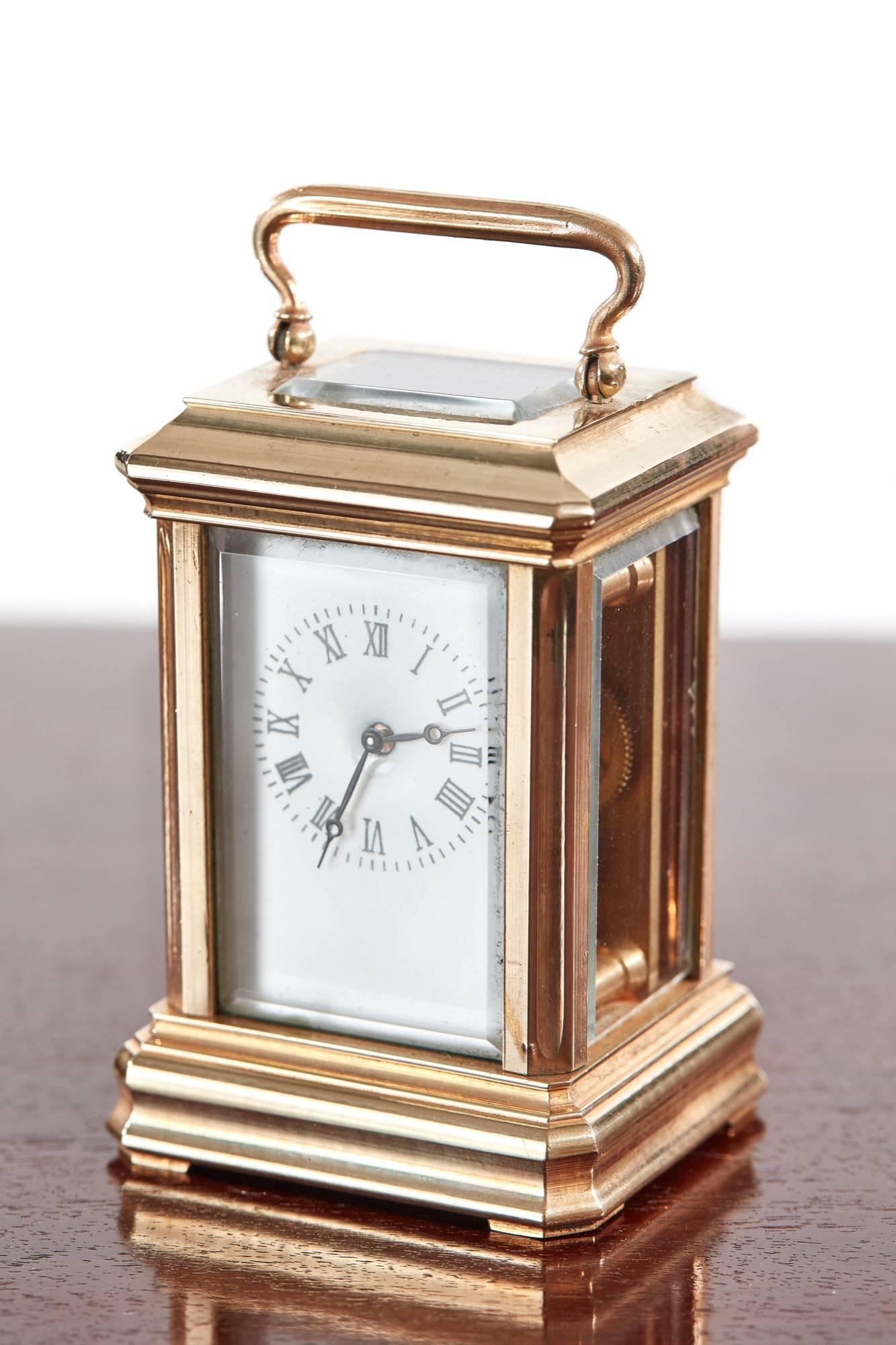 Fine miniature antique French brass carriage clock, with a porcelain dial and bevelled edge glass to each side, in good working order, original key.