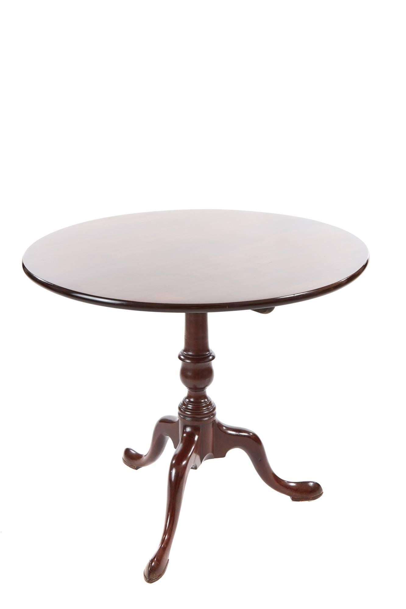 George III mahogany tripod table with a round solid mahogany top on a turned pedestal column raised on three shaped cabriole legs with pad feet
Lovely color and condition.