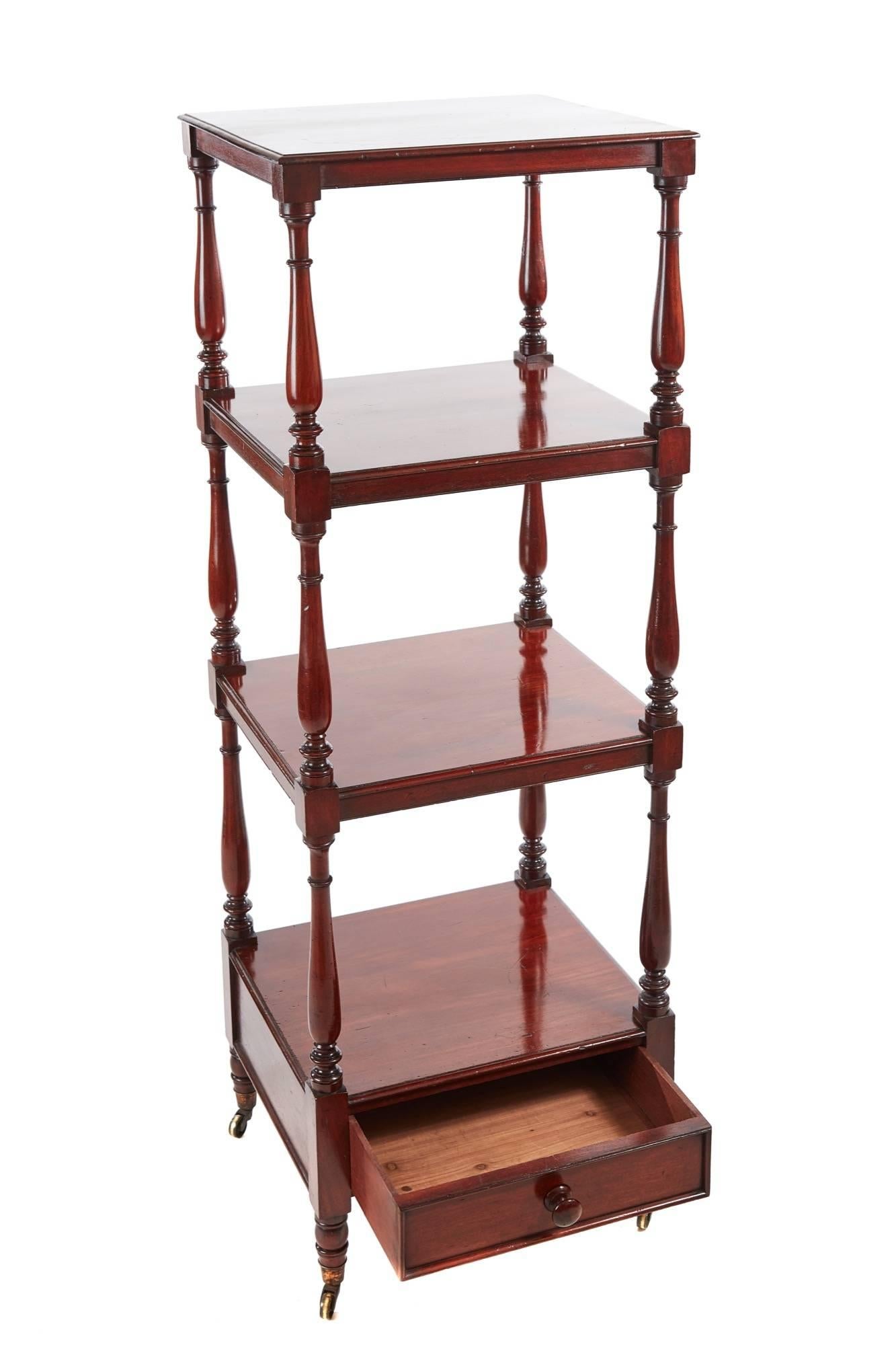 William-IV mahogany freestanding four-tier whatnot, the tiers have turned mahogany supports and finials to the top tier, single drawer to the base with original turned mahogany knob, raised on turned legs with original castors
Fantastic color and