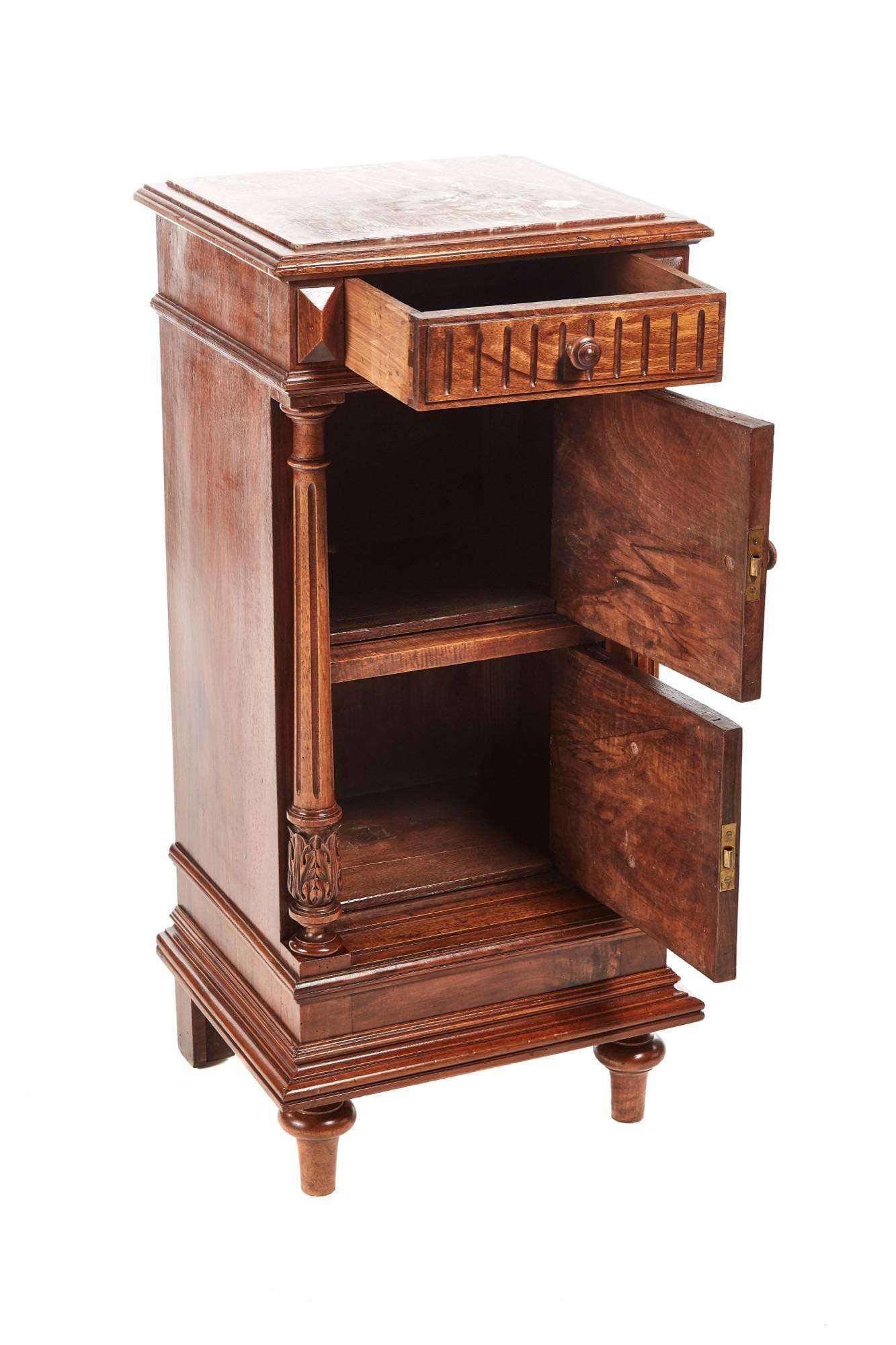 Unusual French walnut bedside cabinet with a marble top drawer to the frieze two cupboard doors lovely carved walnut columns shaped plinth standing on turned legs to the front,
Lovely color and condition
Measures: 17