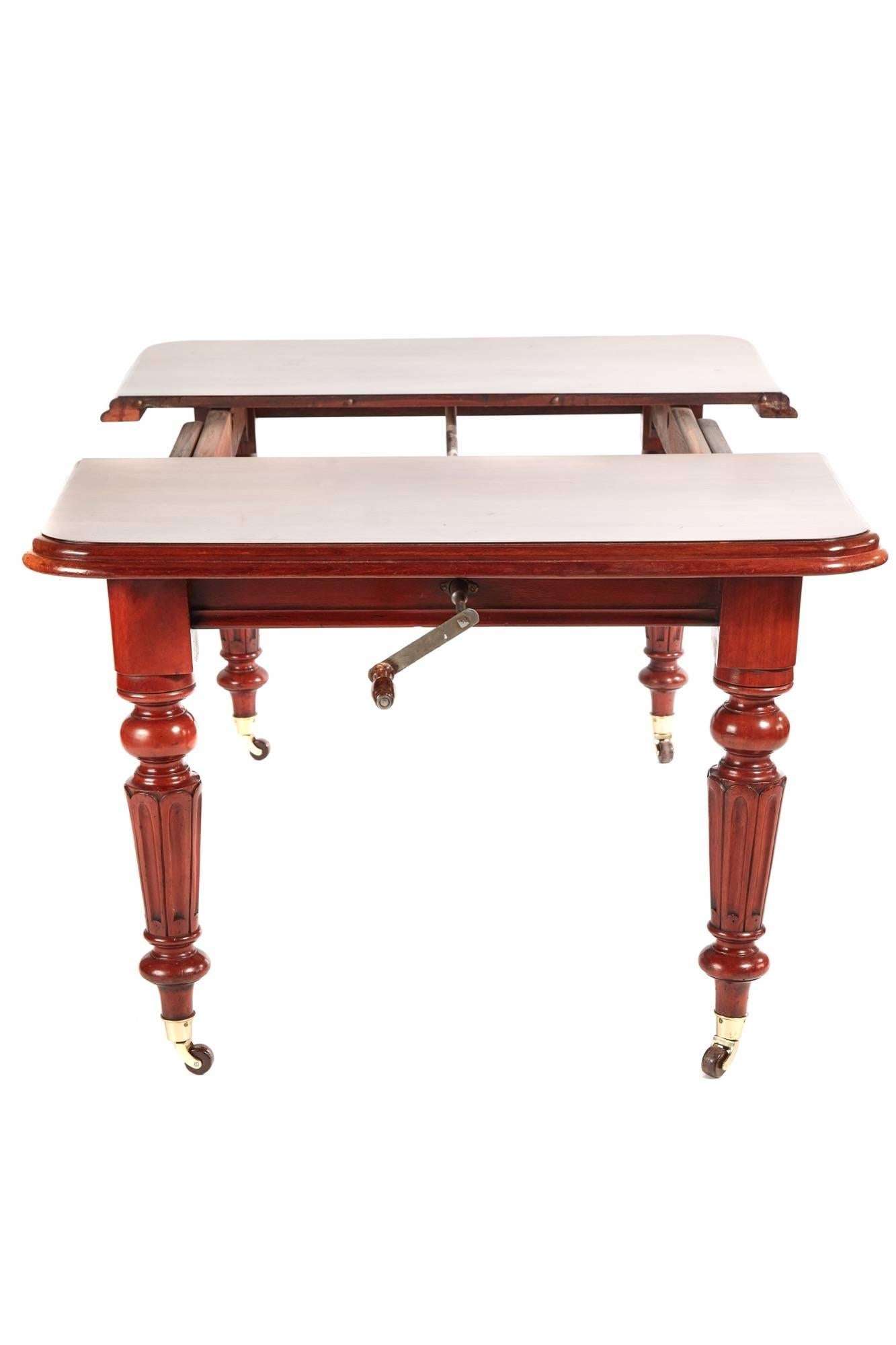 Victorian mahogany extending dining table, fantastic mahogany top with double moulded edge, one extra leaf, standing on four turned reeded legs, original winding handle
Fantastic color and condition
open 56