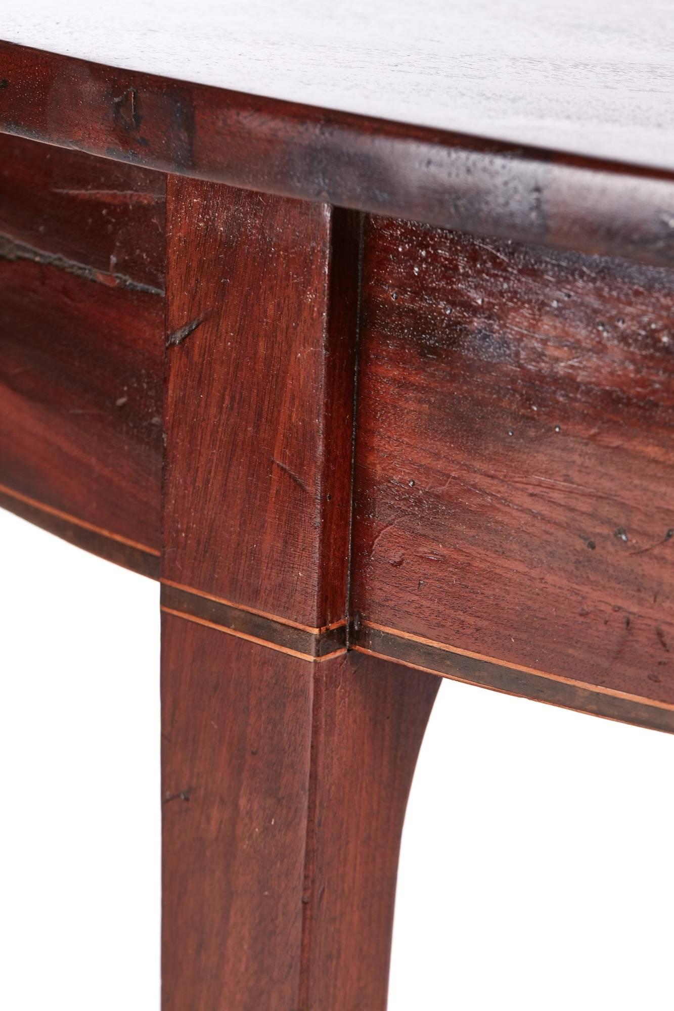 Georgian mahogany demilune console table with a lovely quality mahogany top, shaped frieze with satinwood inlay, standing on four square tapering legs
Lovely color and condition
Measure: 44