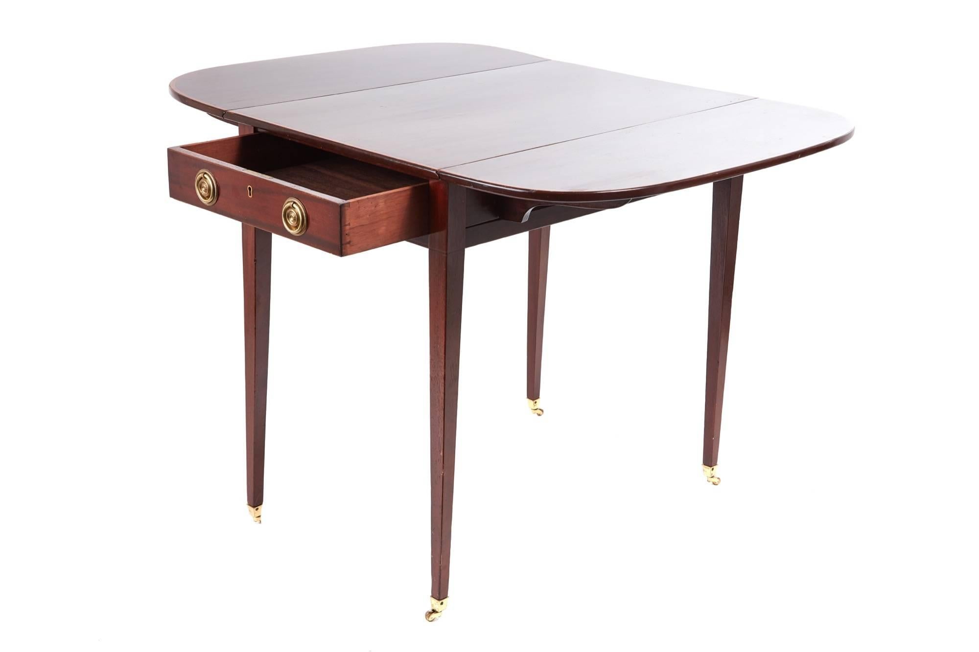 Georgian mahogany pembroke table, with a lovely mahogany top, two drop leaves, cross banded in satinwood, one frieze drawer with original brass handles, standing on four elegant square tapering legs with original brass castors
Lovely color and